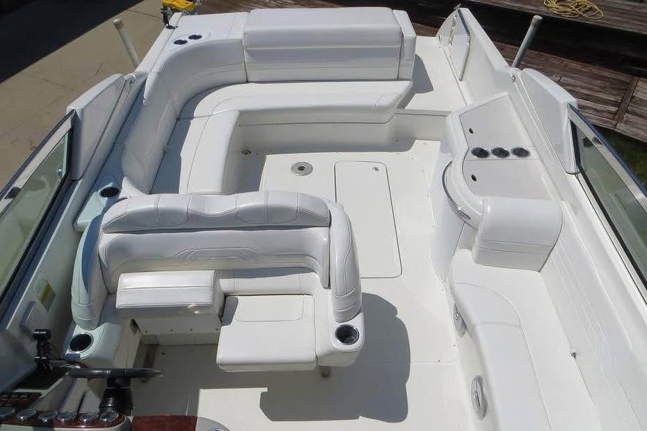 2003 Formula 330 Sun Sport boat interior with white seating and cup holders.
