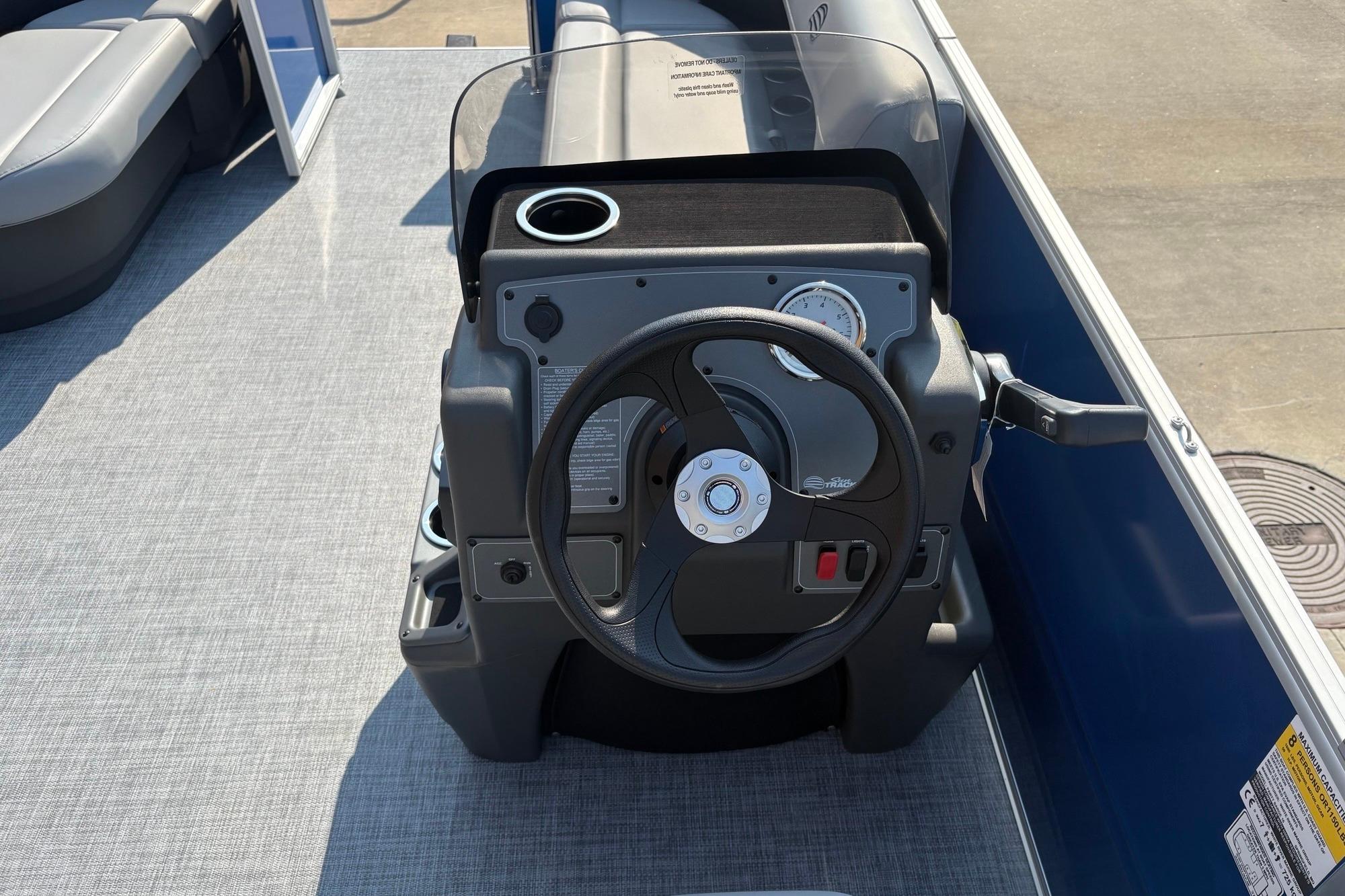2026 Sun Tracker Party Barge 16 DLX steering console with modern controls and cup holder.