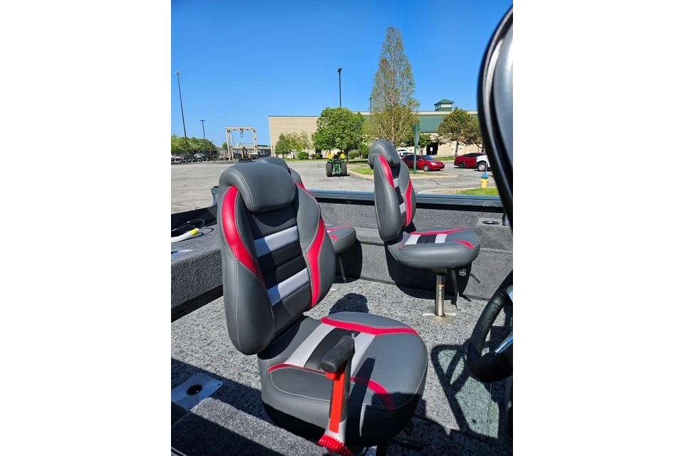 2026 Ranger VS1882SC Angler boat seats with red and gray design in a parking lot.