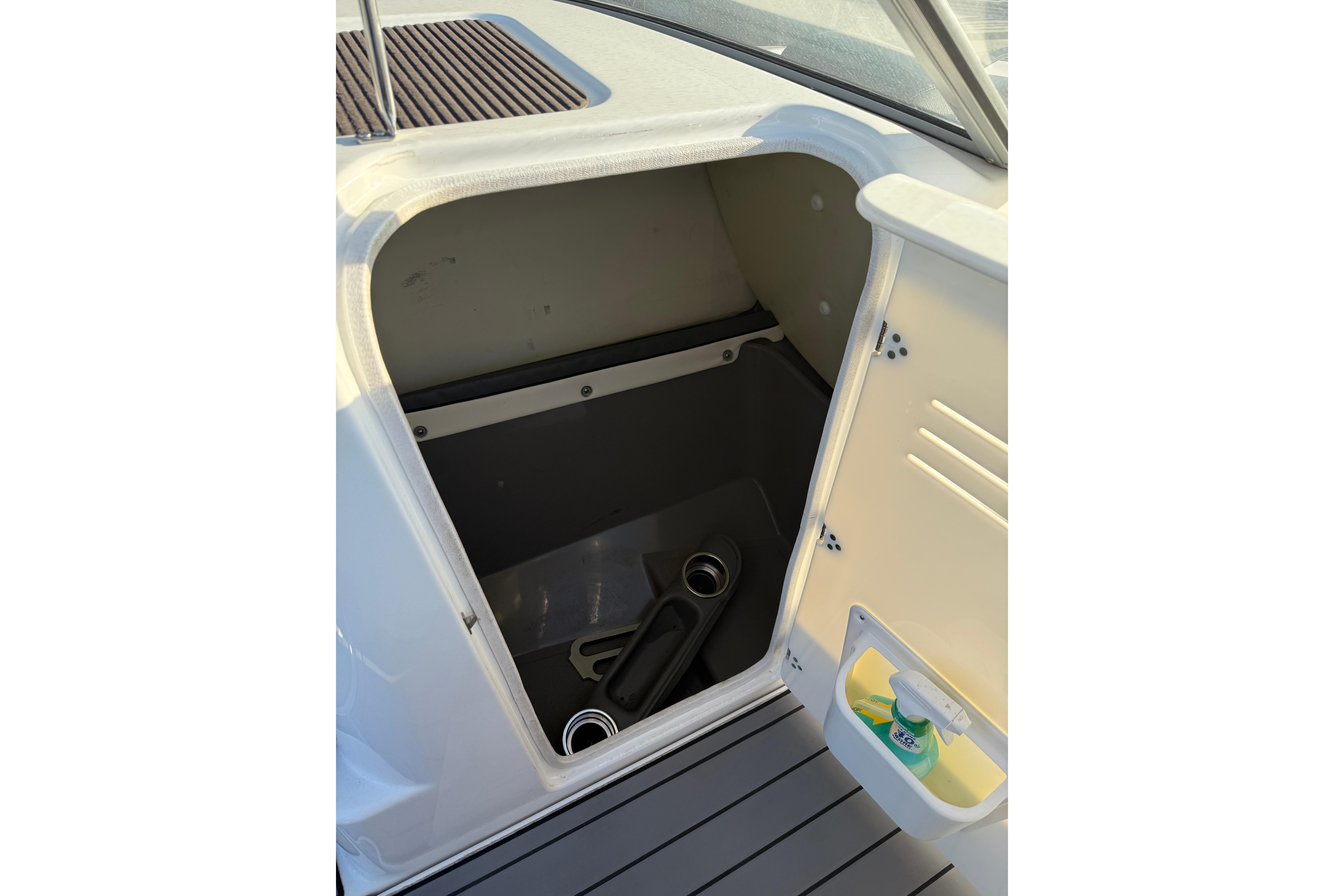 Storage compartment on a 2011 Yamaha Boats 242 Limited S, open with visible interior.