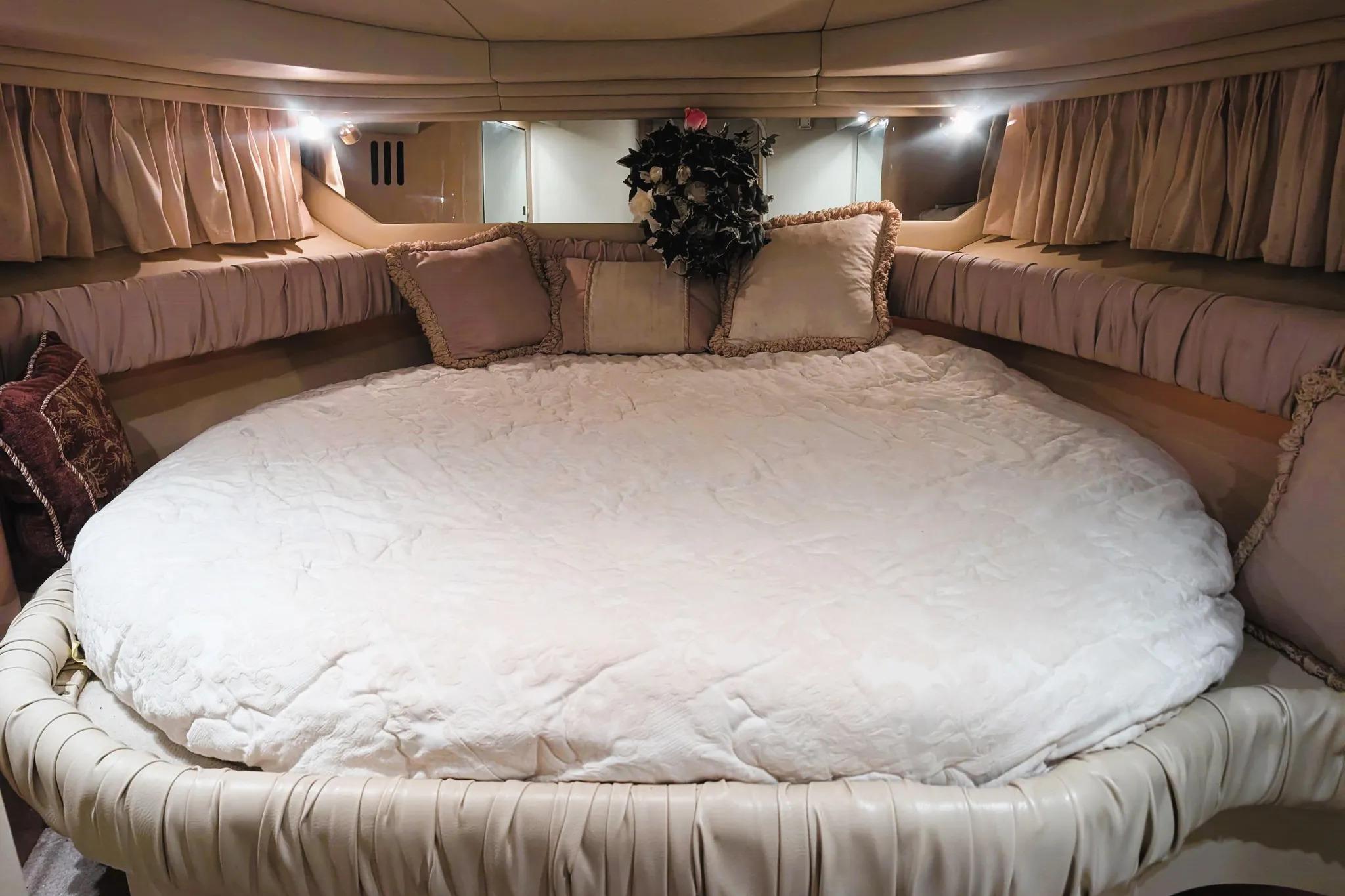 Luxurious interior cabin of 2000 Sea Ray 380 Sundancer with plush bedding and elegant decor.