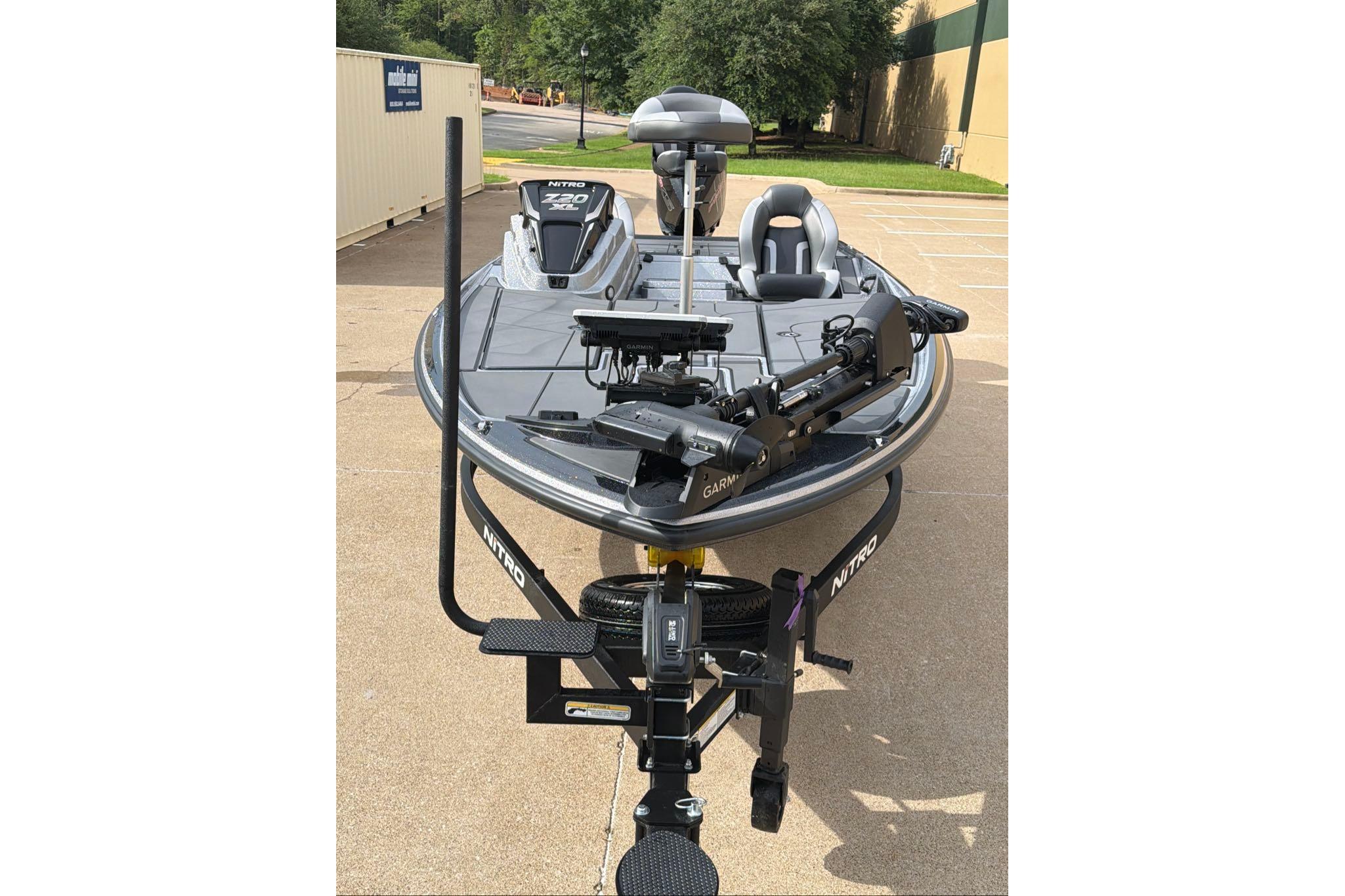 2026 Nitro Z20 XL fishing boat with advanced Garmin equipment, parked outdoors.