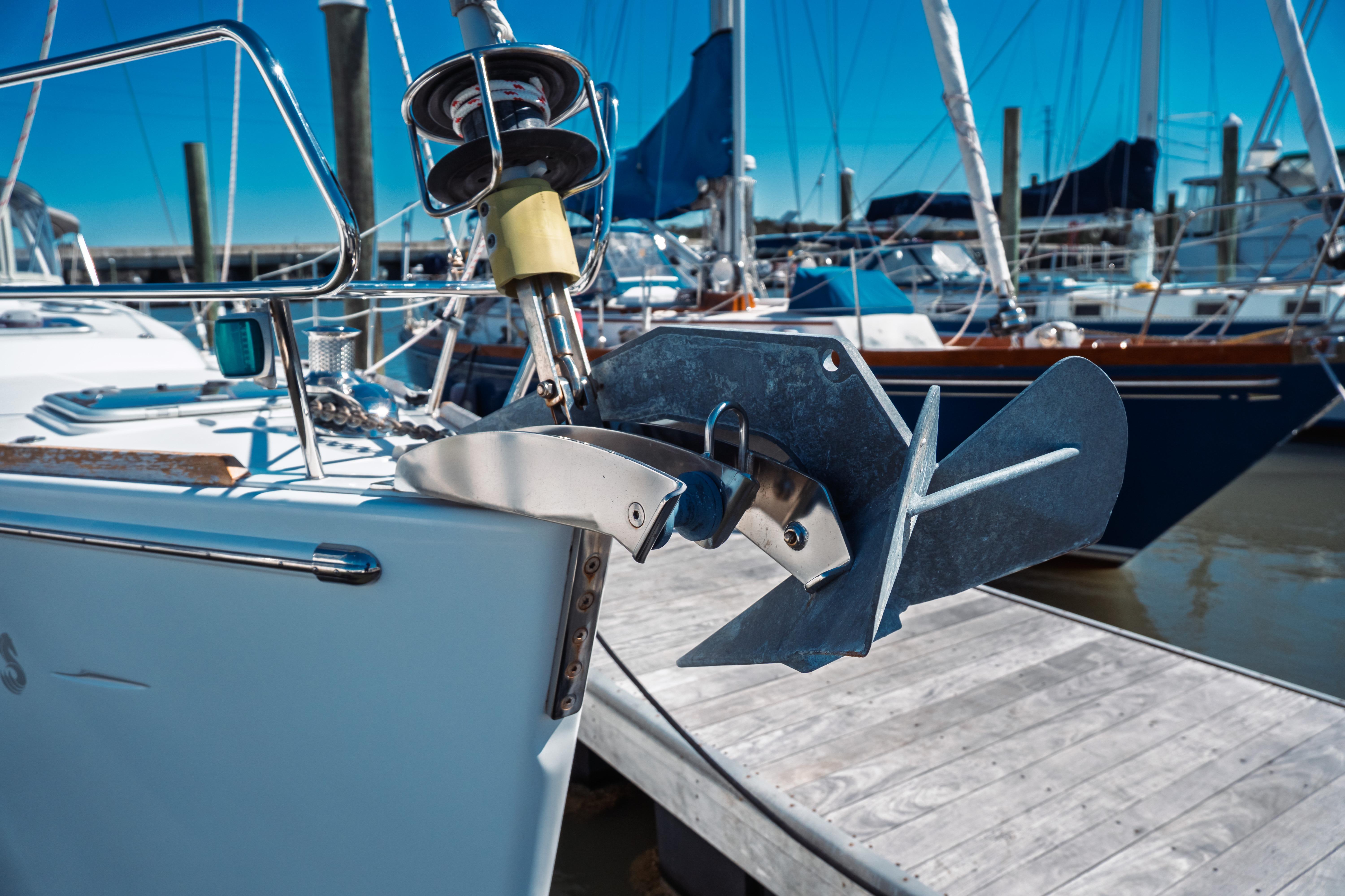 Bow of 2011 Beneteau Oceanis 50 yacht with anchor at marina dock.