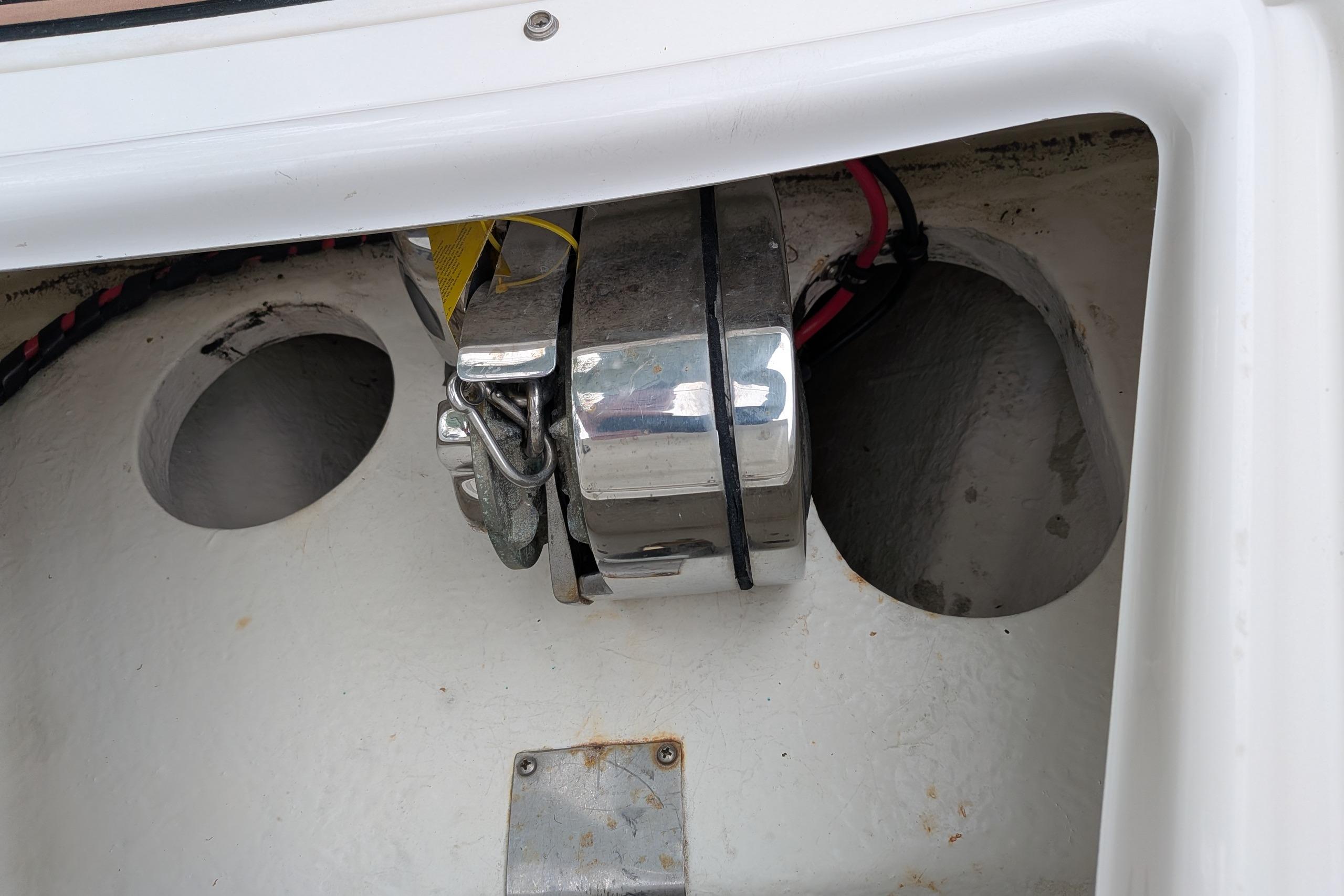 Storage compartment of a 2016 Brig E780 boat with visible wiring and metal components.