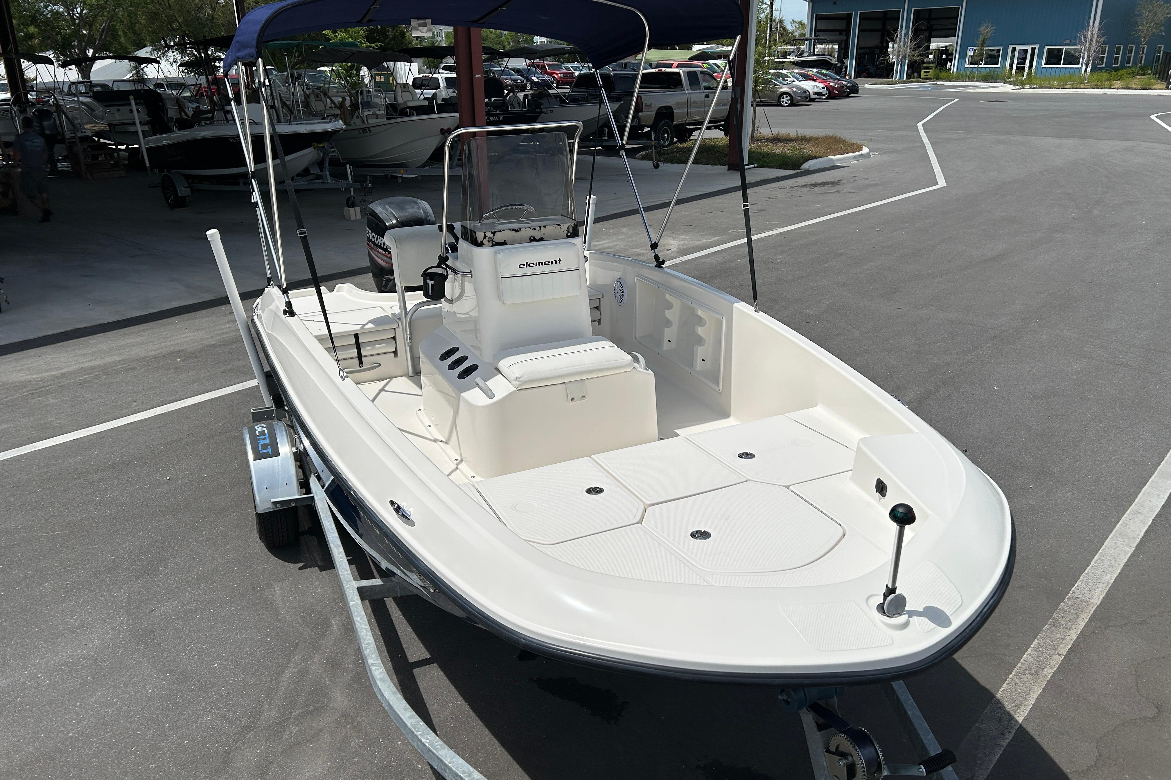 2018 Bayliner Element F16 boat on trailer in parking lot.