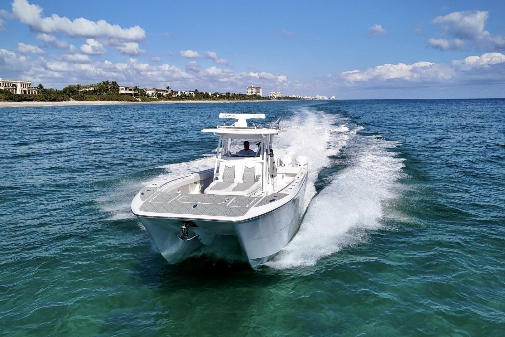 2024 Invincible 35 Catamaran cruising on clear blue ocean waters.