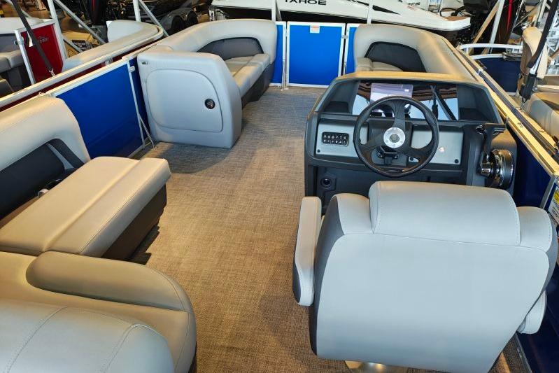 2026 Sun Tracker Party Barge 18 DLX interior with plush seating and modern helm.
