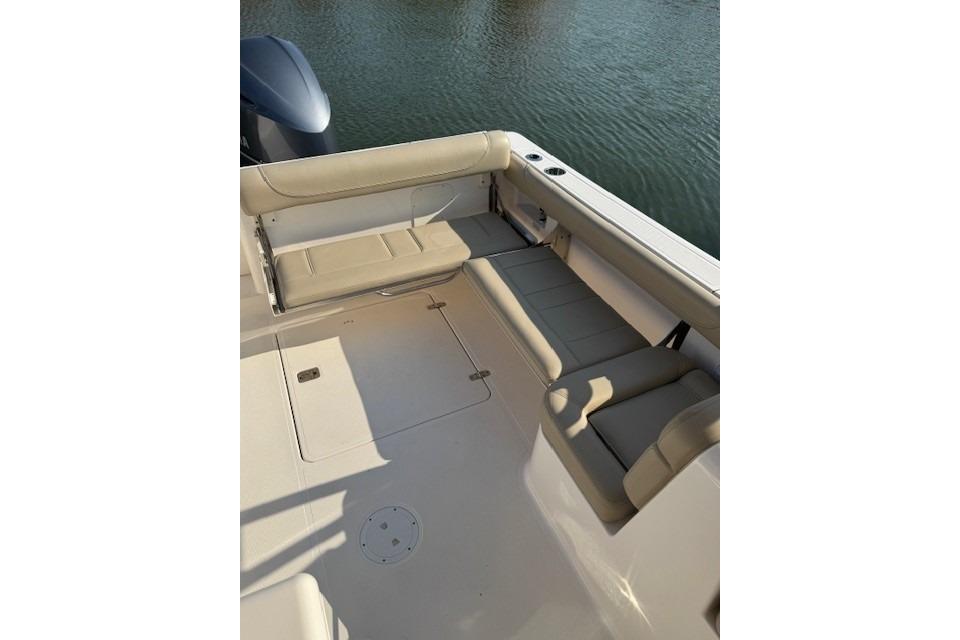 2015 Pursuit DC 265 Dual Console boat interior with beige seating and water view.