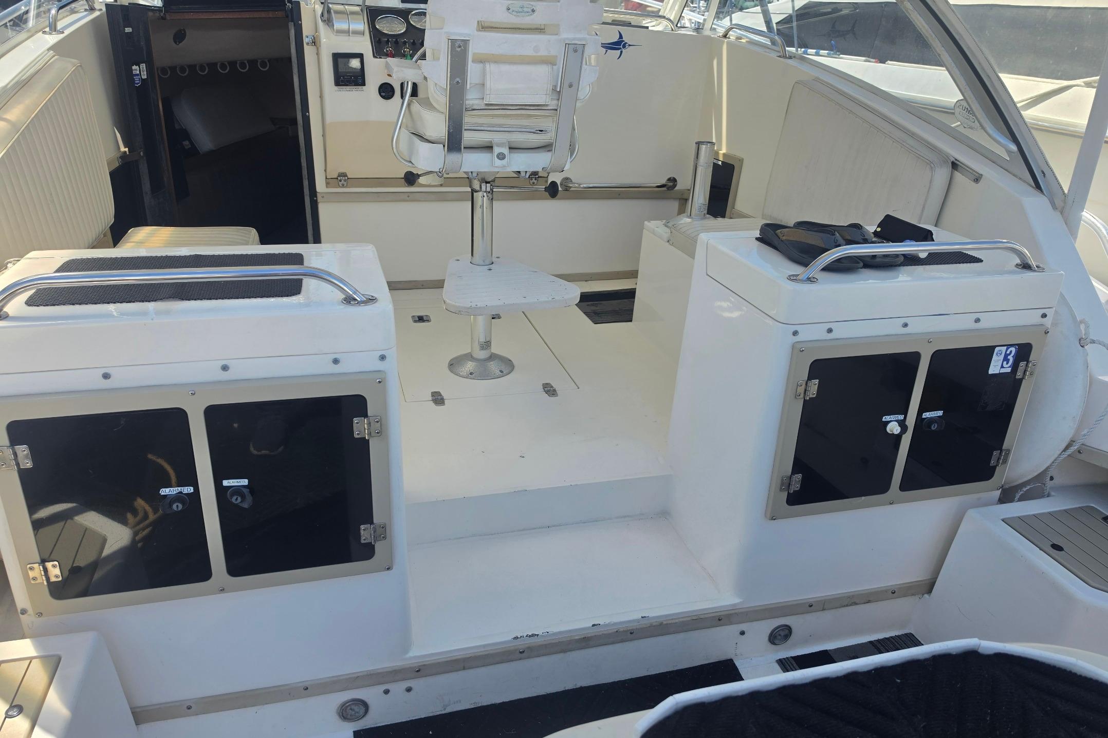 1999 Albemarle 305 Express Fisherman boat interior with seating and storage compartments.