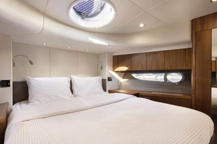 Luxurious cabin interior of 2016 Sunseeker Manhattan 64 yacht with elegant wood finishes.