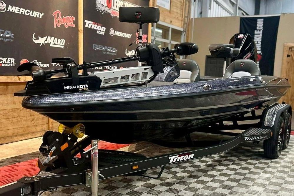 2026 Triton 18 TrX bass boat on display with Minn Kota Ultrex motor.