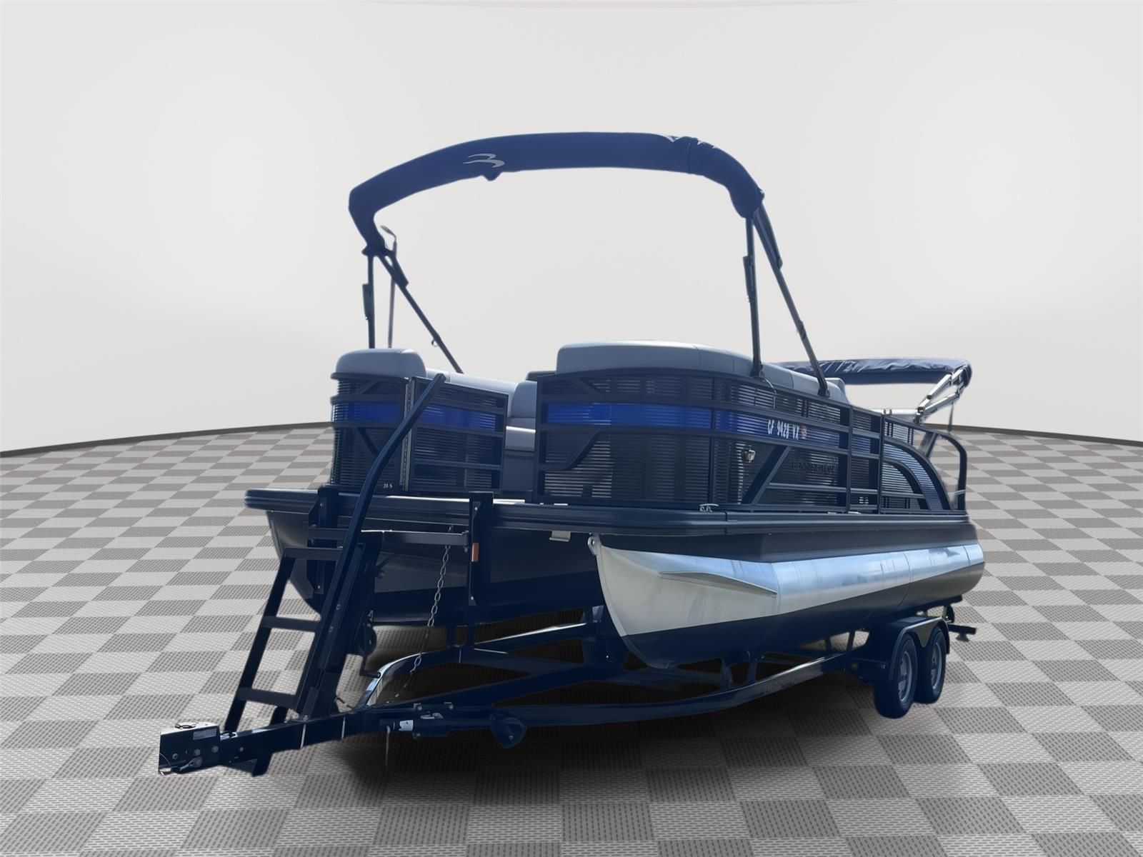 A 2025 Bennington S20 pontoon boat on a trailer in a showroom setting.