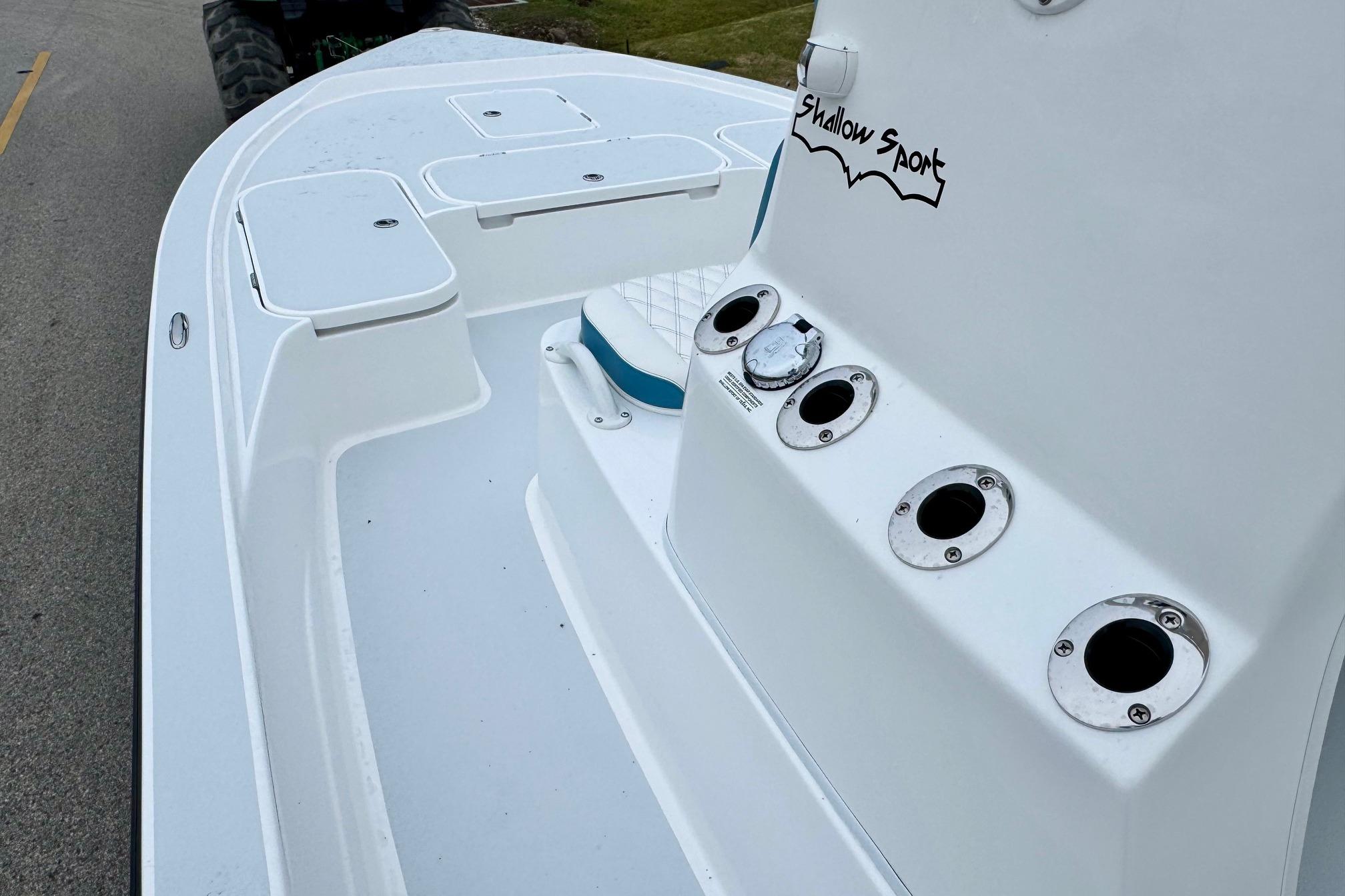 2026 Shallow Sport 24 Modified V boat deck with rod holders and storage compartments.