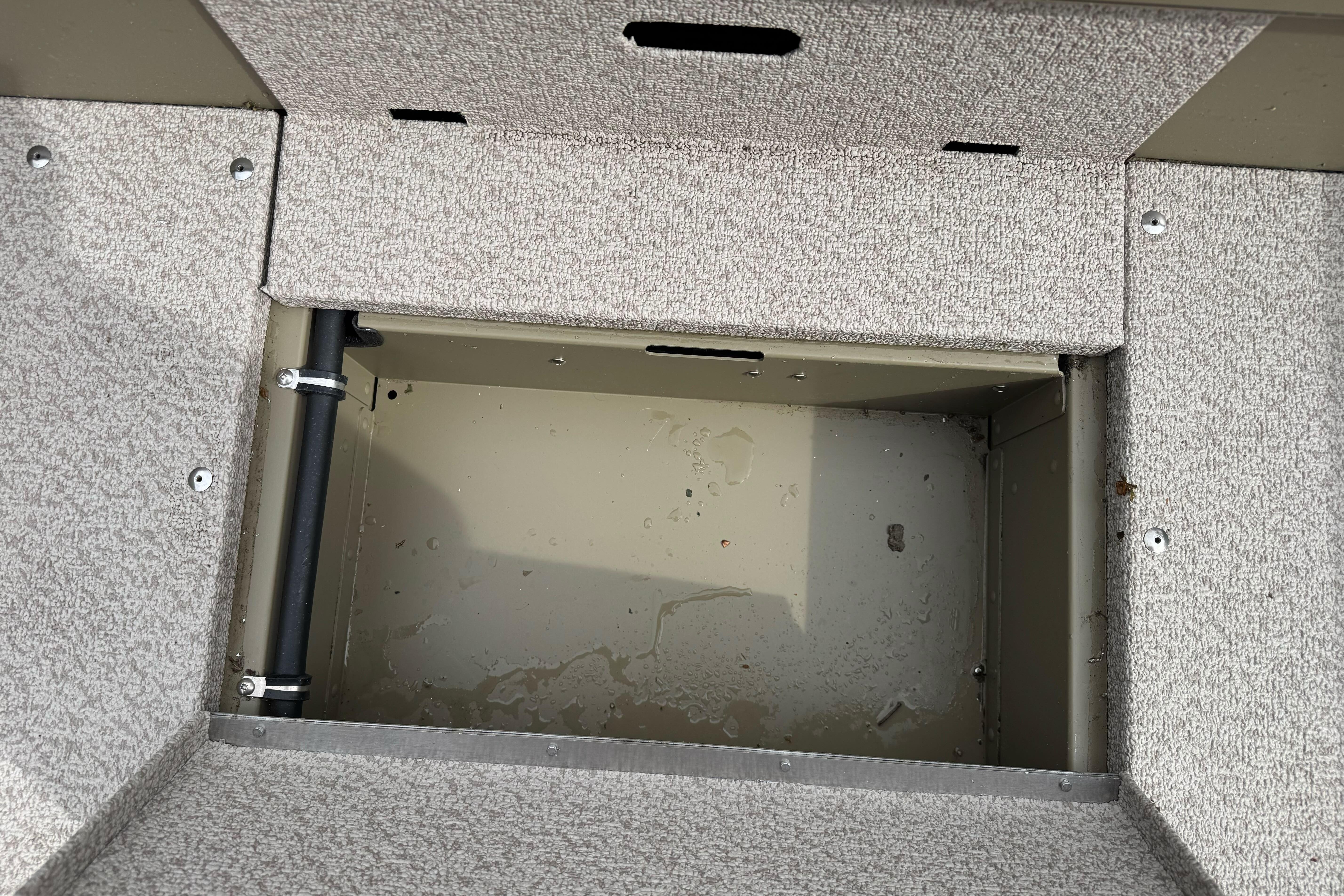 Open storage compartment in 2026 Lund 2075 Alaskan SS boat interior.