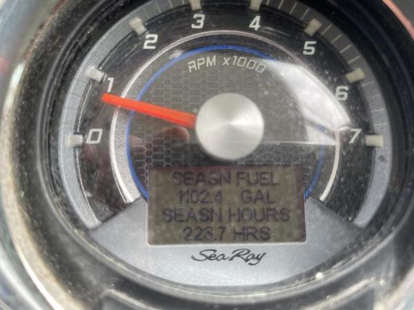 Close-up of Sea Ray 310 Sundancer 2014 RPM gauge showing fuel and hours.