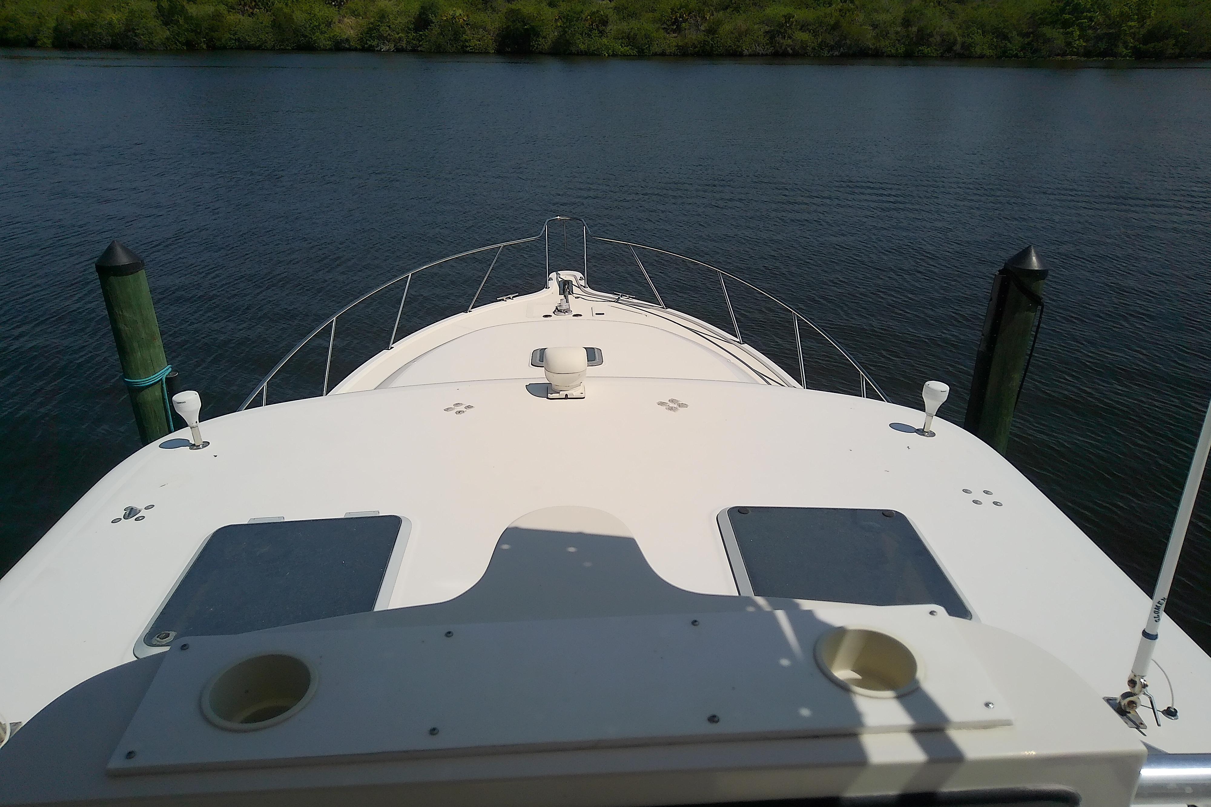 Bow view of a 2000 Tiara Yachts 4100 Open on calm water.