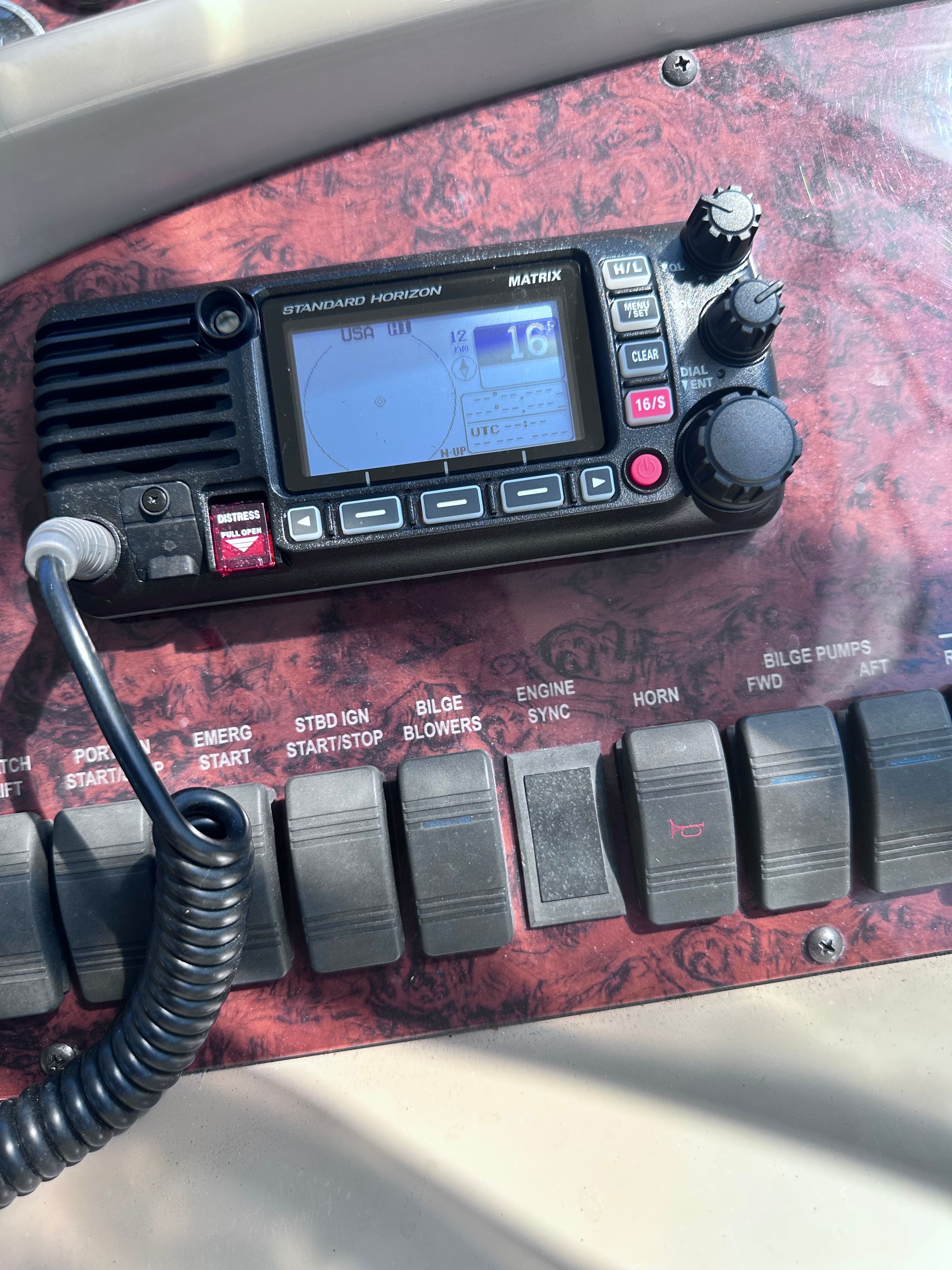 Control panel of a 2000 Sea Ray 380 Sundancer with radio and switches.