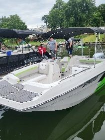 A white 2023 Starcraft SVX 191 OB boat on the water. It features an open deck and sunshade.