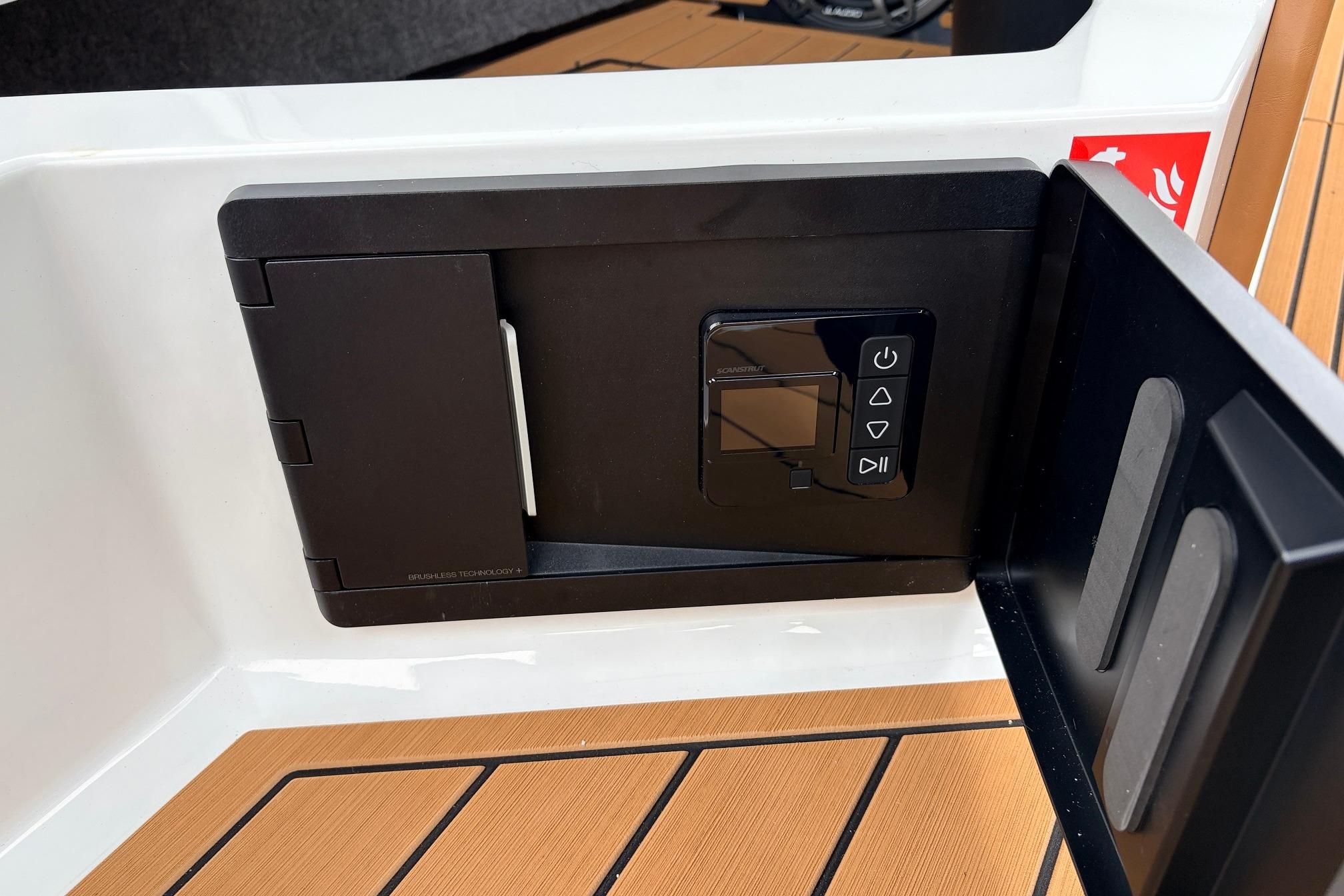 Control panel on 2026 Nautique Super Air Nautique G25 boat, featuring sleek black design.