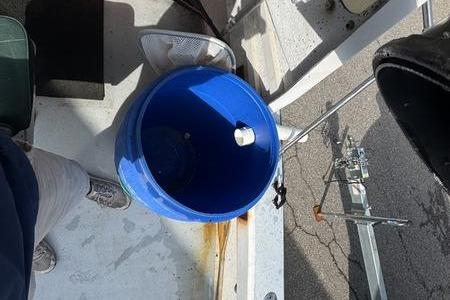 Blue bucket on 2001 ROS Boats 19 RUNABOUT deck, near fishing rod holder.