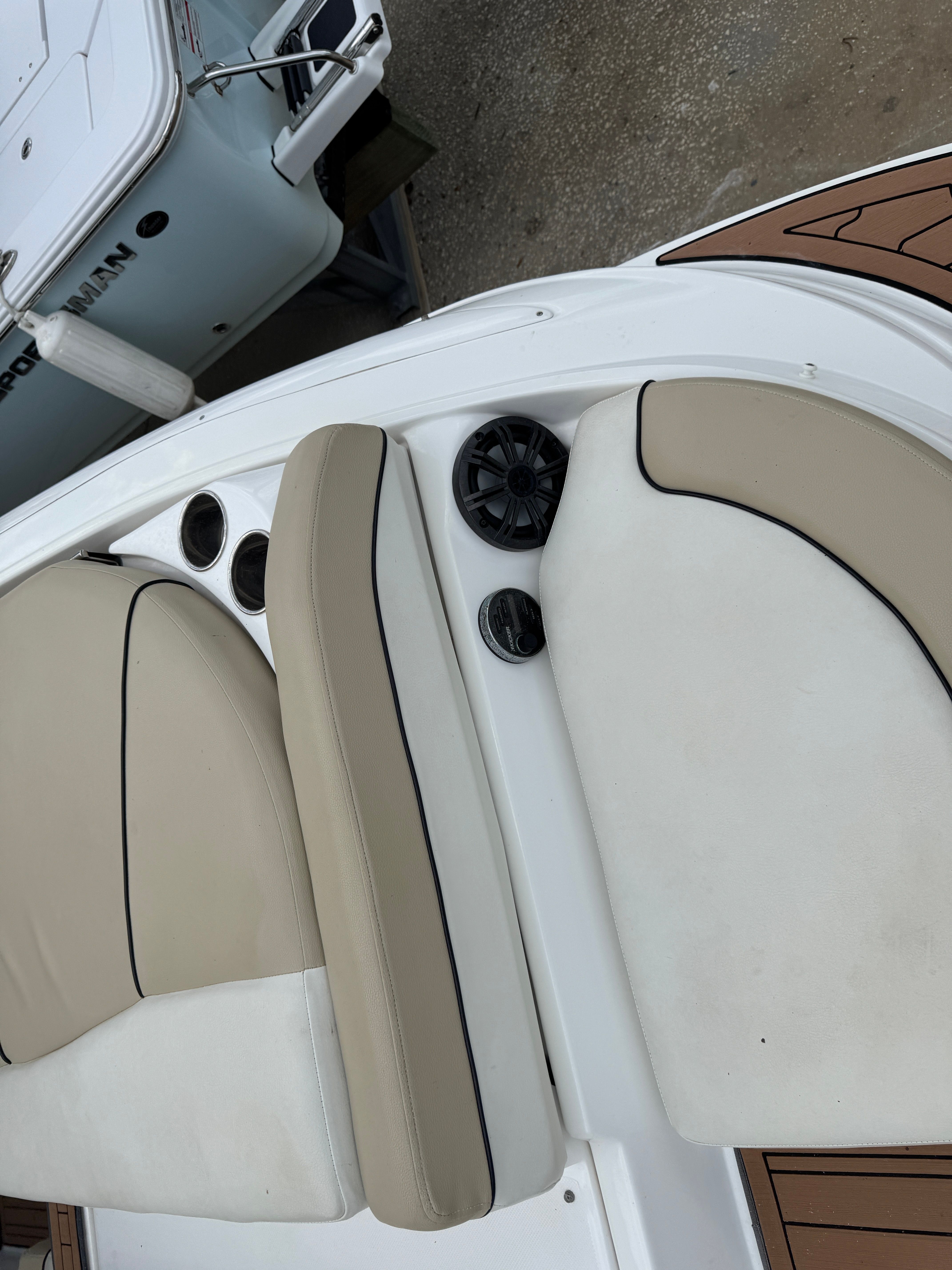 Interior of a 2017 Rinker QX29 BR boat with beige seats.