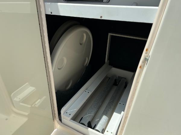 Storage compartment in a 2005 Sea Ray 220 Sundeck boat.