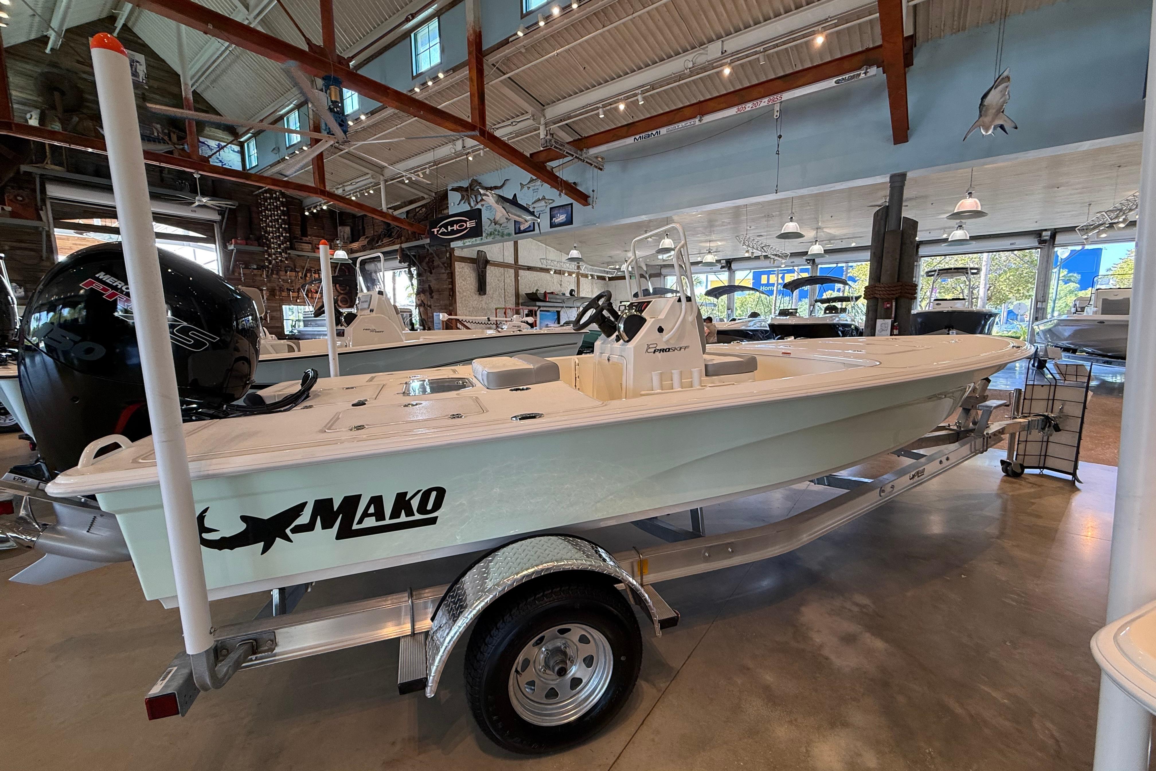 2026 Mako 18 Pro Skiff boat displayed in a showroom, featuring sleek design and modern features.
