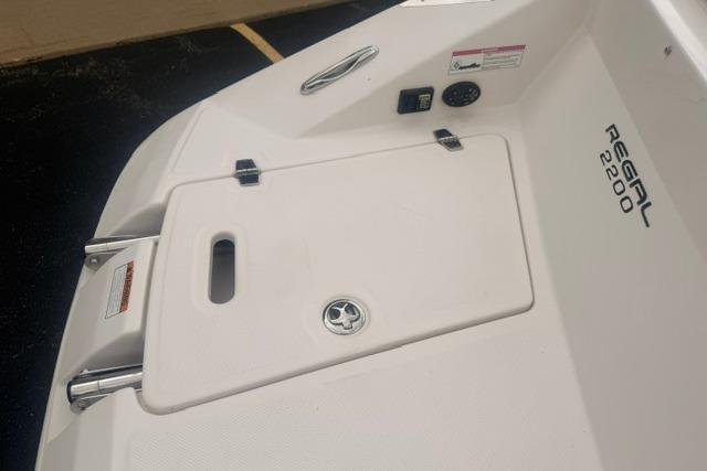 2007 Regal 2200 Bowrider boat deck with storage compartment and branding.