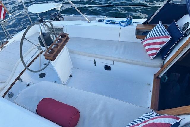 Cockpit of 1987 Catalina 30 Mk II sailboat with seating and nautical decor.