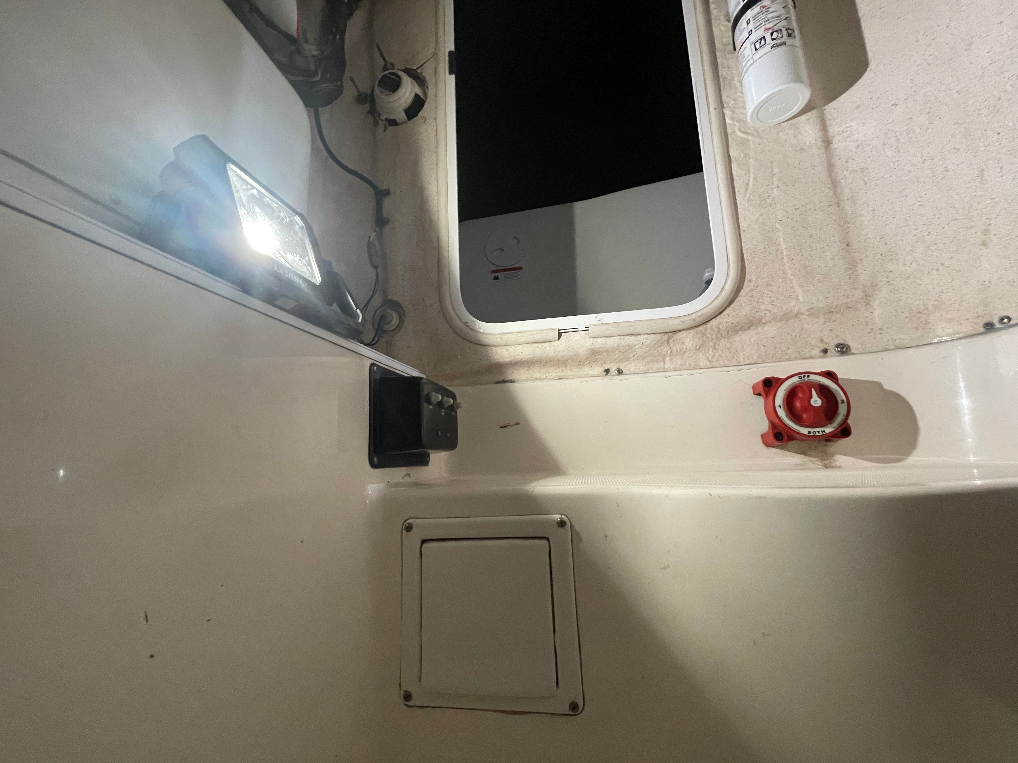 Interior of a 2005 Aquasport 210 Osprey boat with light and switch.