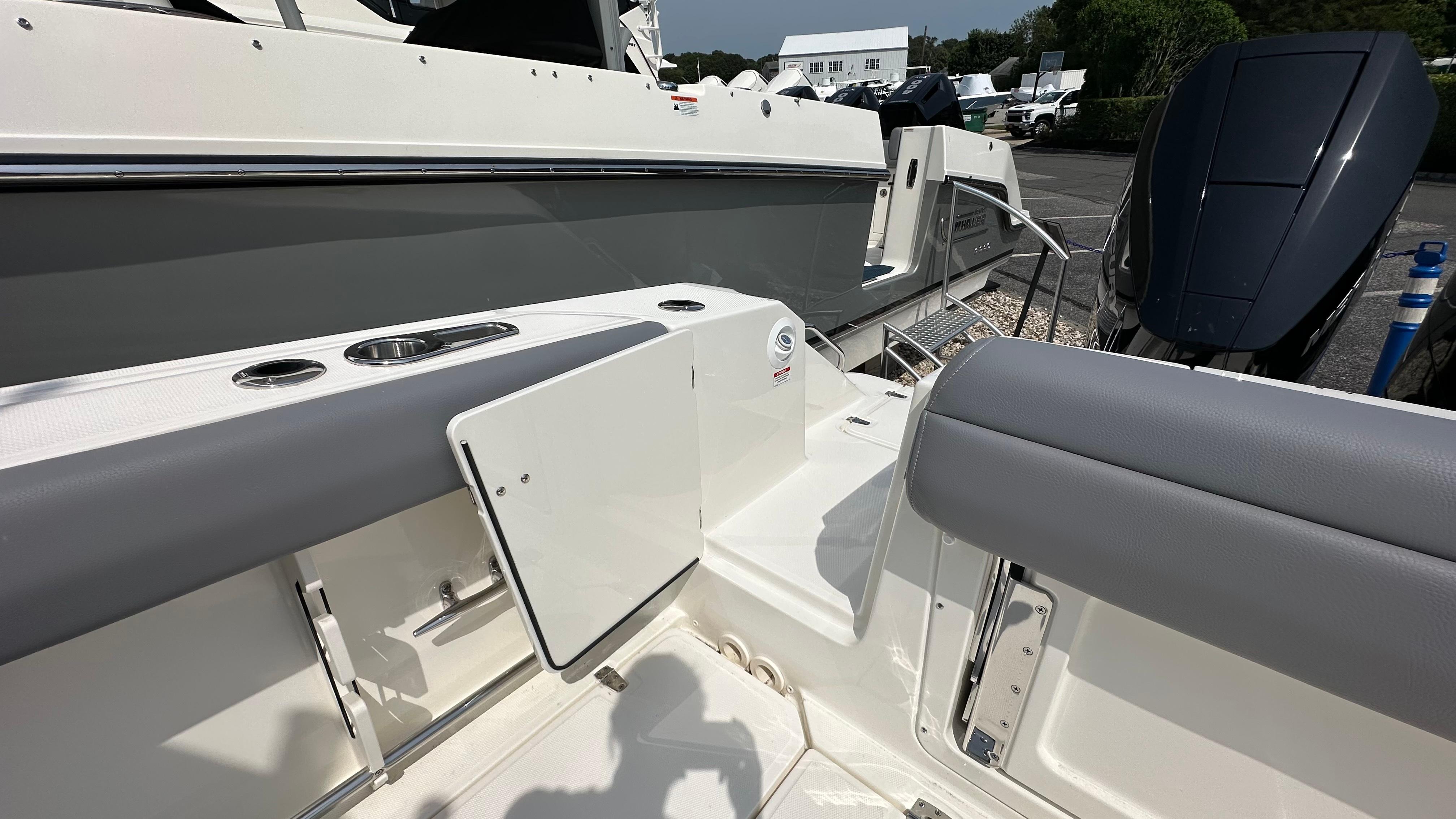 2025 Boston Whaler 330 Outrage boat interior with seating and storage compartments.