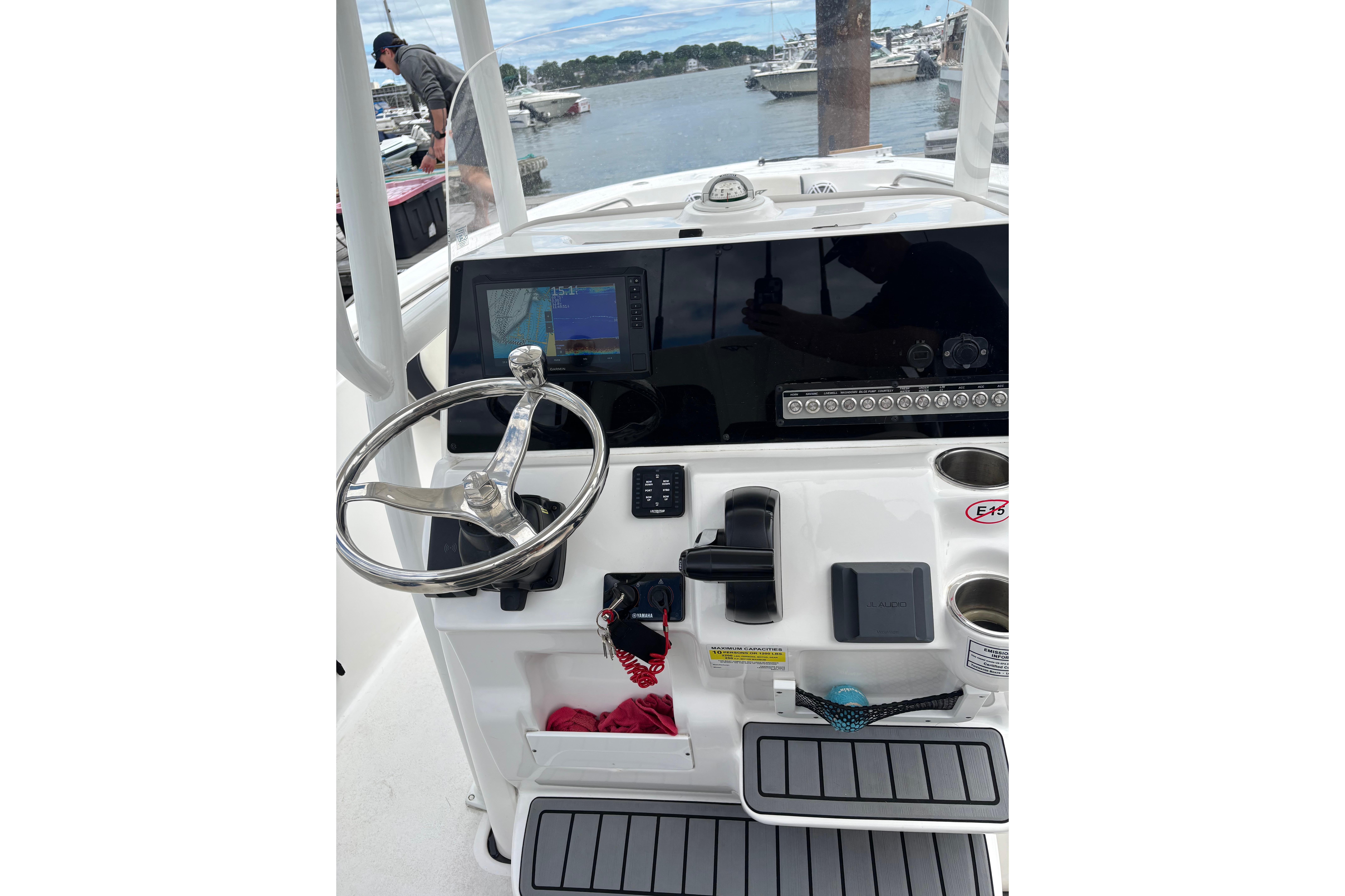 2024 Tidewater 220 CC Adventure boat dashboard with steering wheel and navigation display.