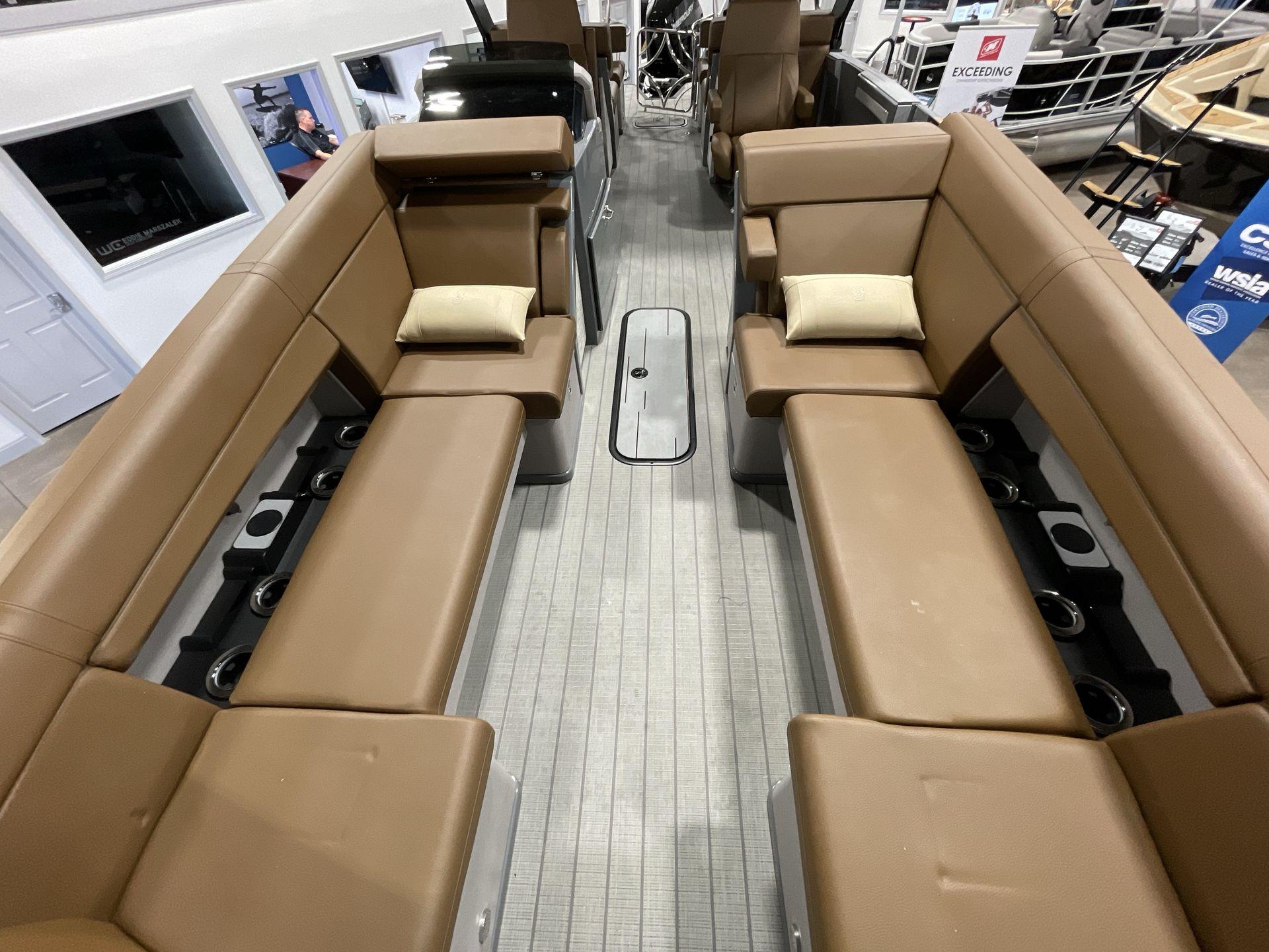 Interior of 2025 Balise Horizon 26C boat with brown seating and cup holders.