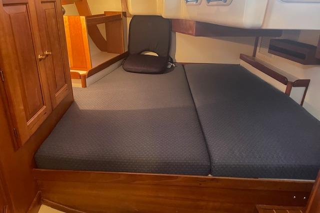 Interior cabin of 2001 Tartan 3700 sailboat with cushioned seating and wooden cabinetry.