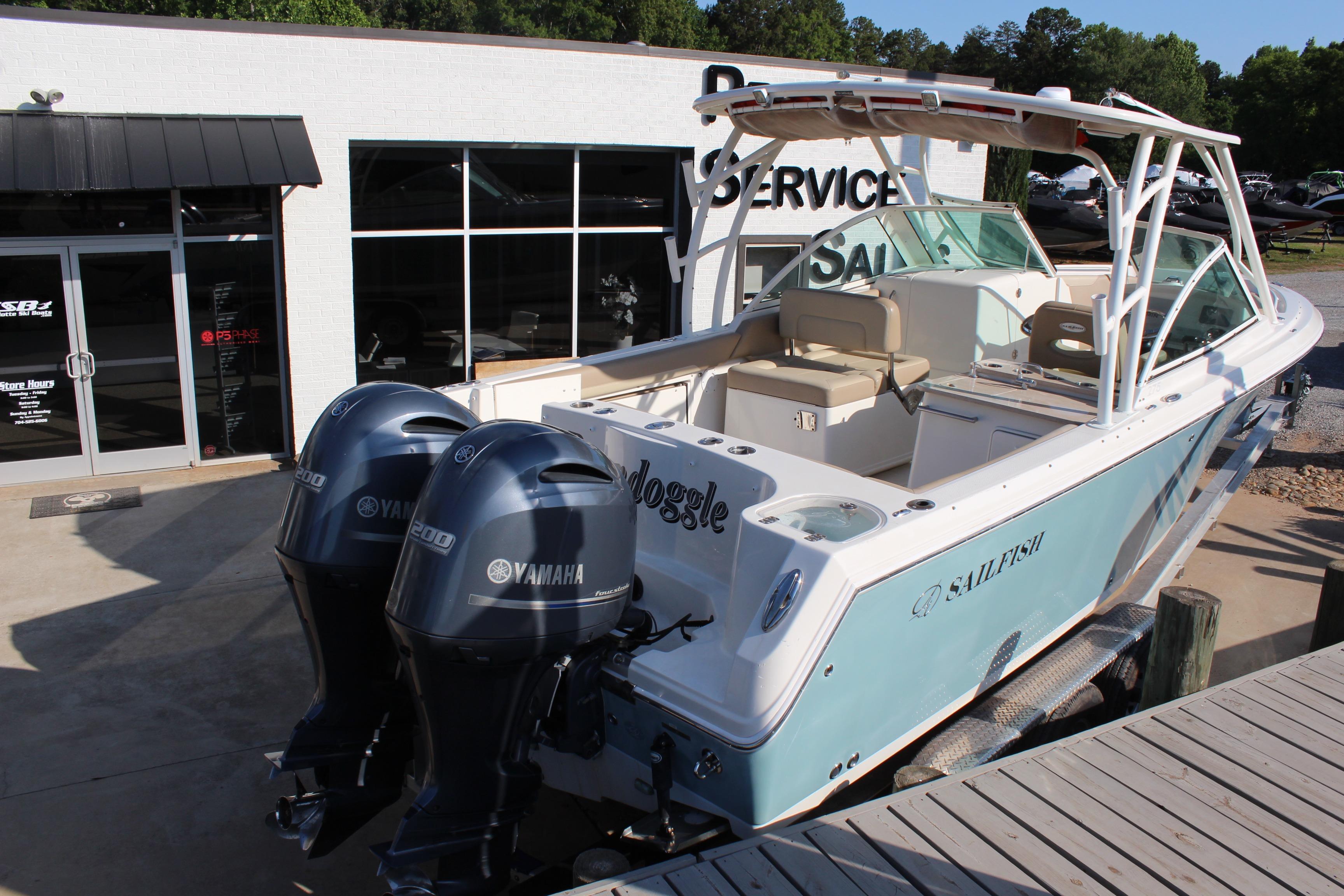2017 Sailfish 275 DC boat with twin Yamaha engines at a service center.