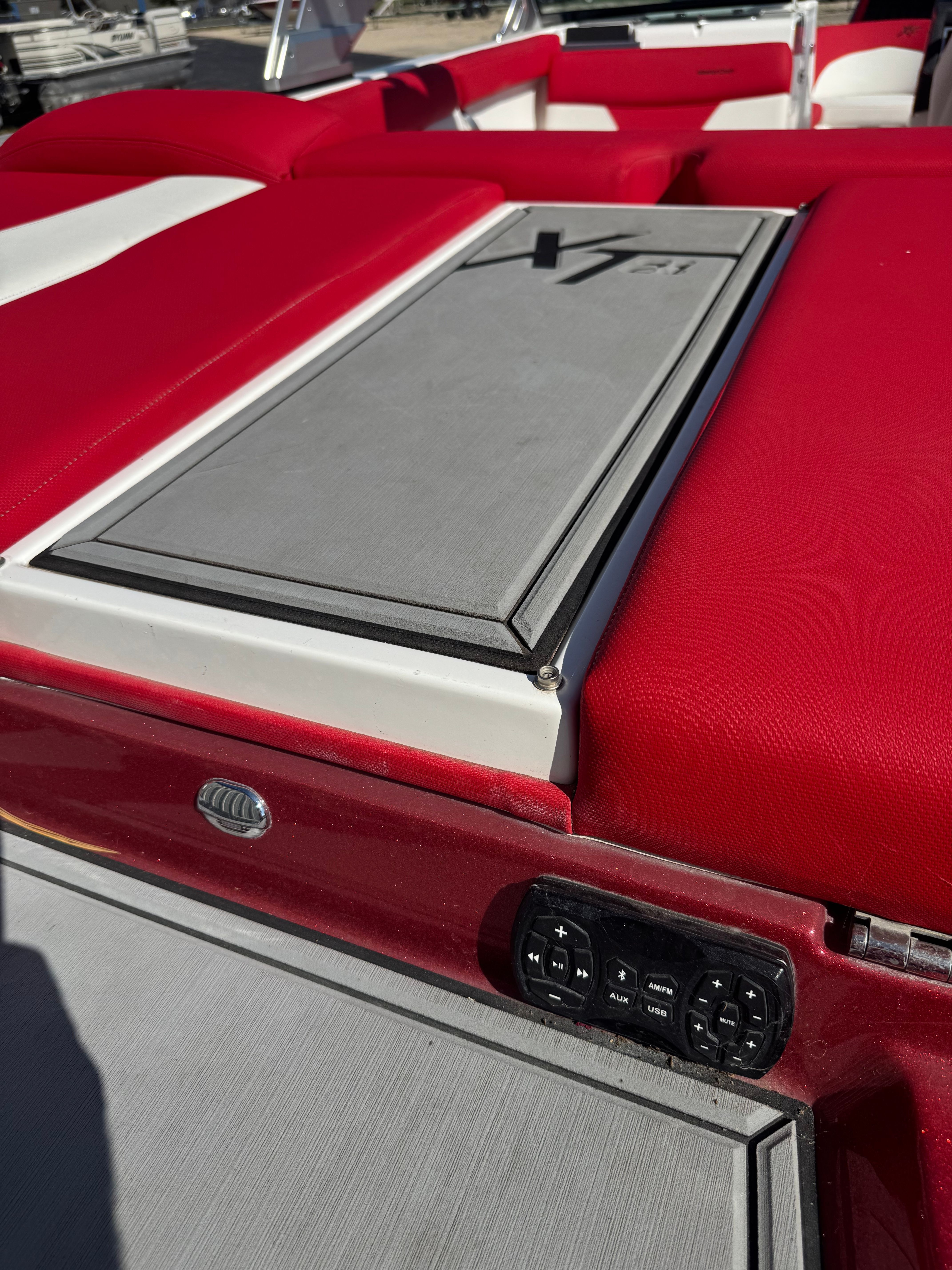 Red interior of a 2019 Master XT21 boat with controls.