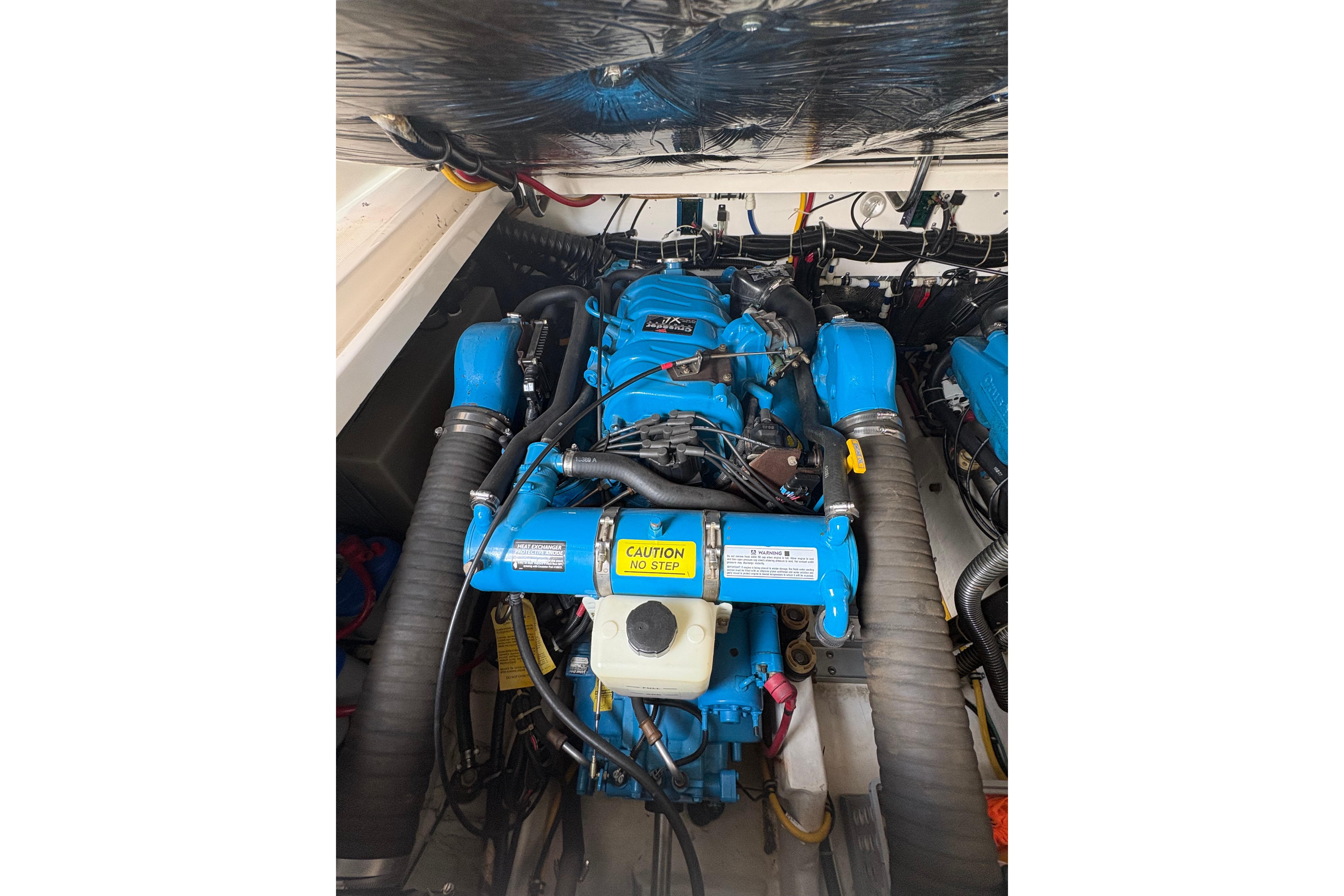 Engine compartment of a 1999 Tiara Yachts 3100 Open, featuring a blue marine engine.