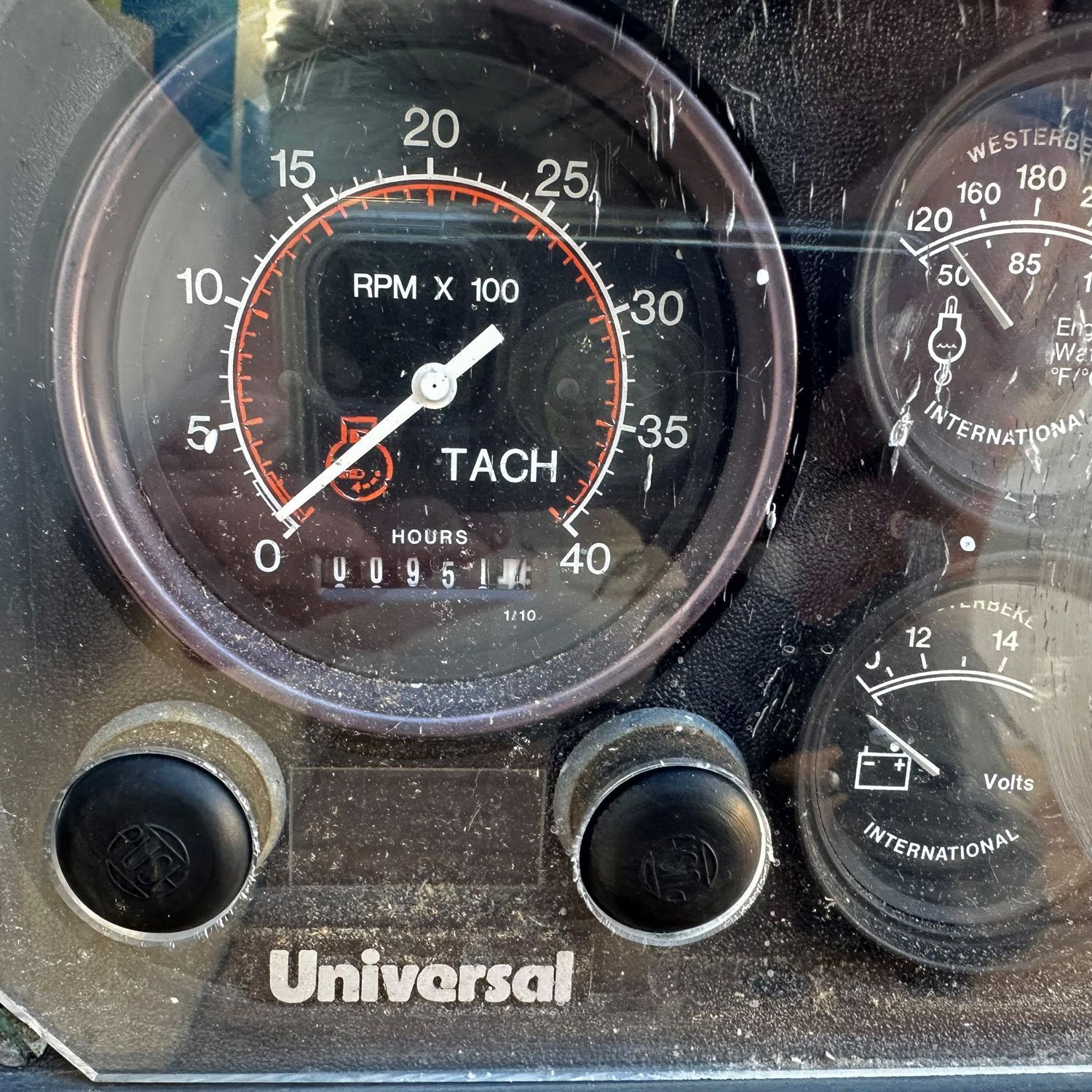 Close-up of a tachometer and other gauges on a boat.