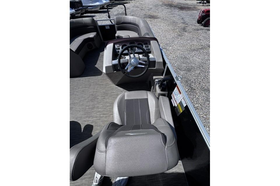 2021 Bennington 23 SSRX boat interior with steering wheel and seating area.