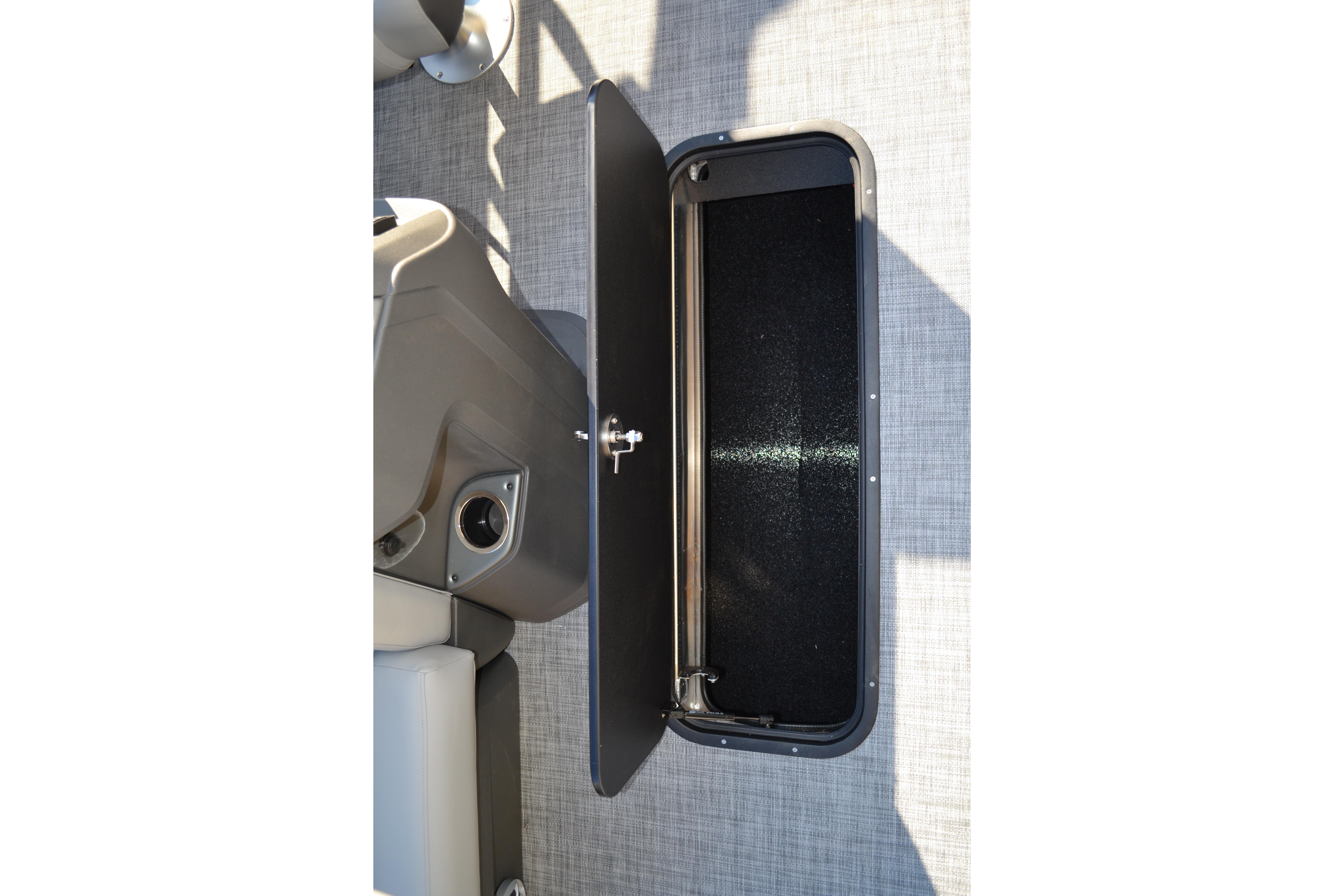 Storage compartment on 2026 Sun Tracker SportFish 22 XP3 boat, open with visible interior.