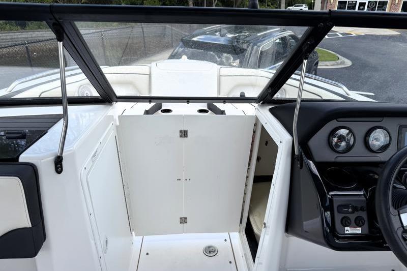 2017 Yamaha Boats SX210 interior dashboard with steering wheel and storage compartment.