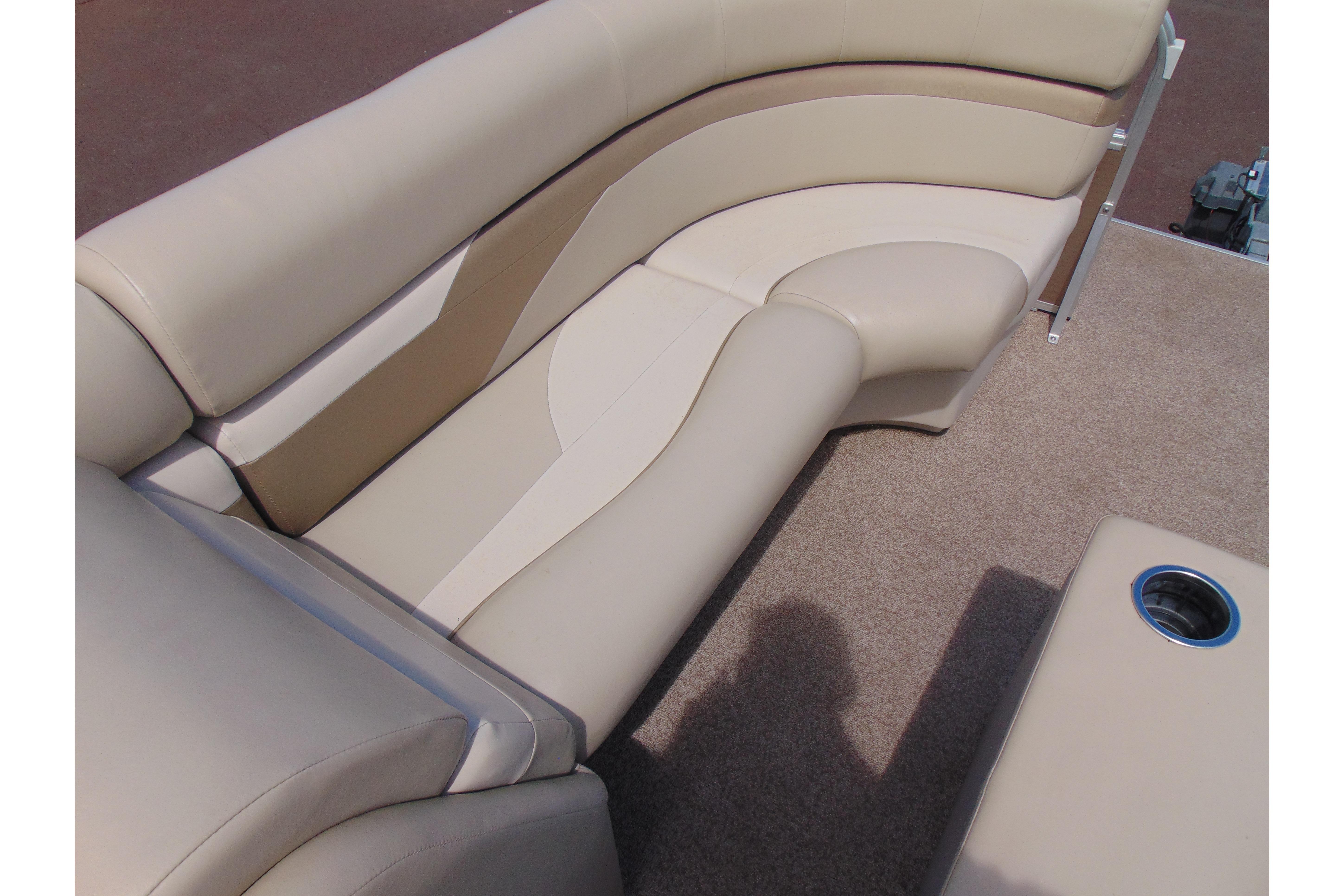 Beige seating on 2016 Misty Harbor 245 Adventure CU boat with cup holder.