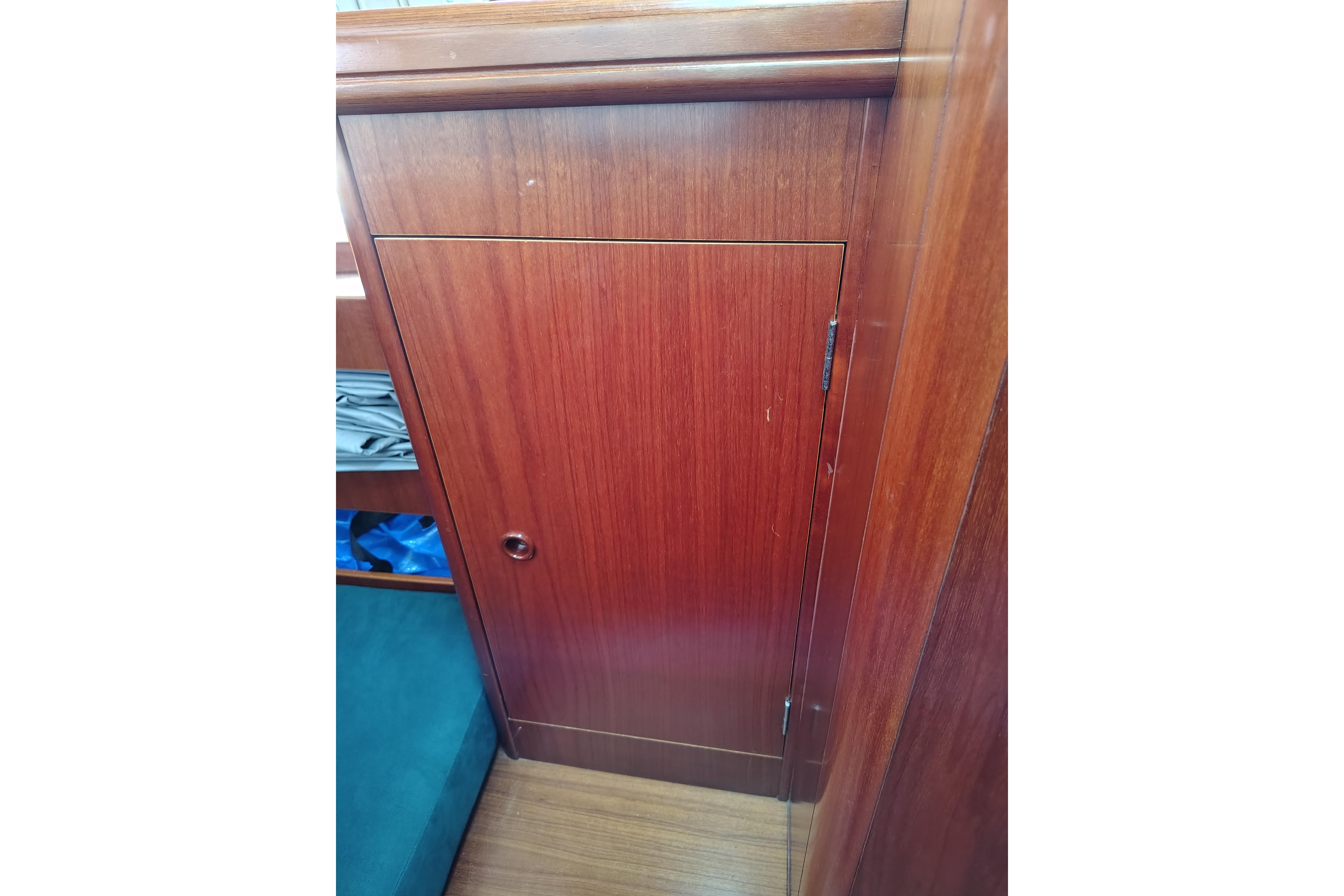 Wooden cabin door inside a 2001 Beneteau Oceanis 411 sailboat interior.