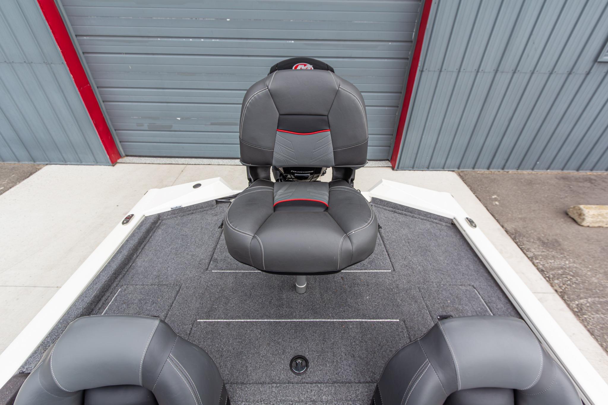 2023 Tracker Pro Team 190 TX boat seat, gray upholstery, red accents, on deck.