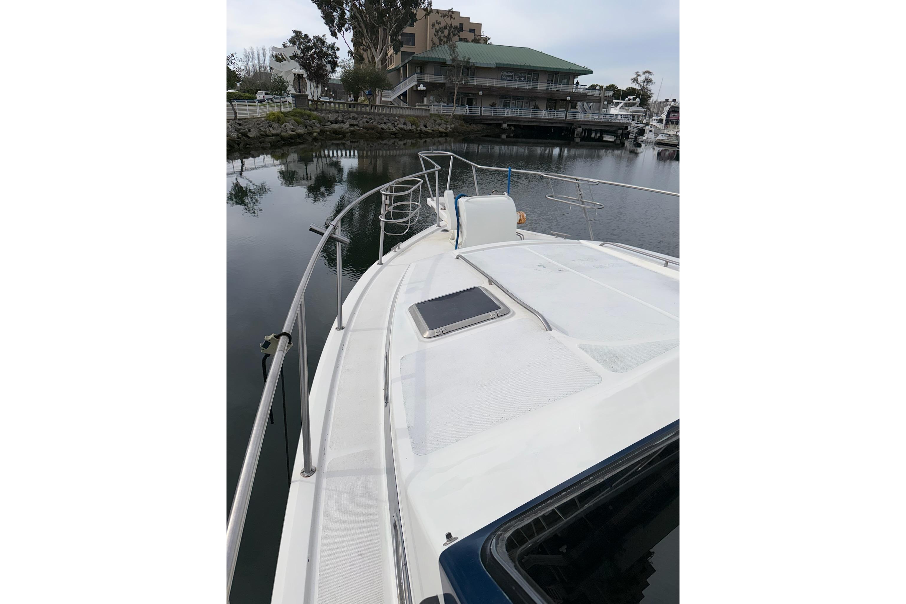 1990 Mediterranean Sport Fish boat docked in a serene marina setting.