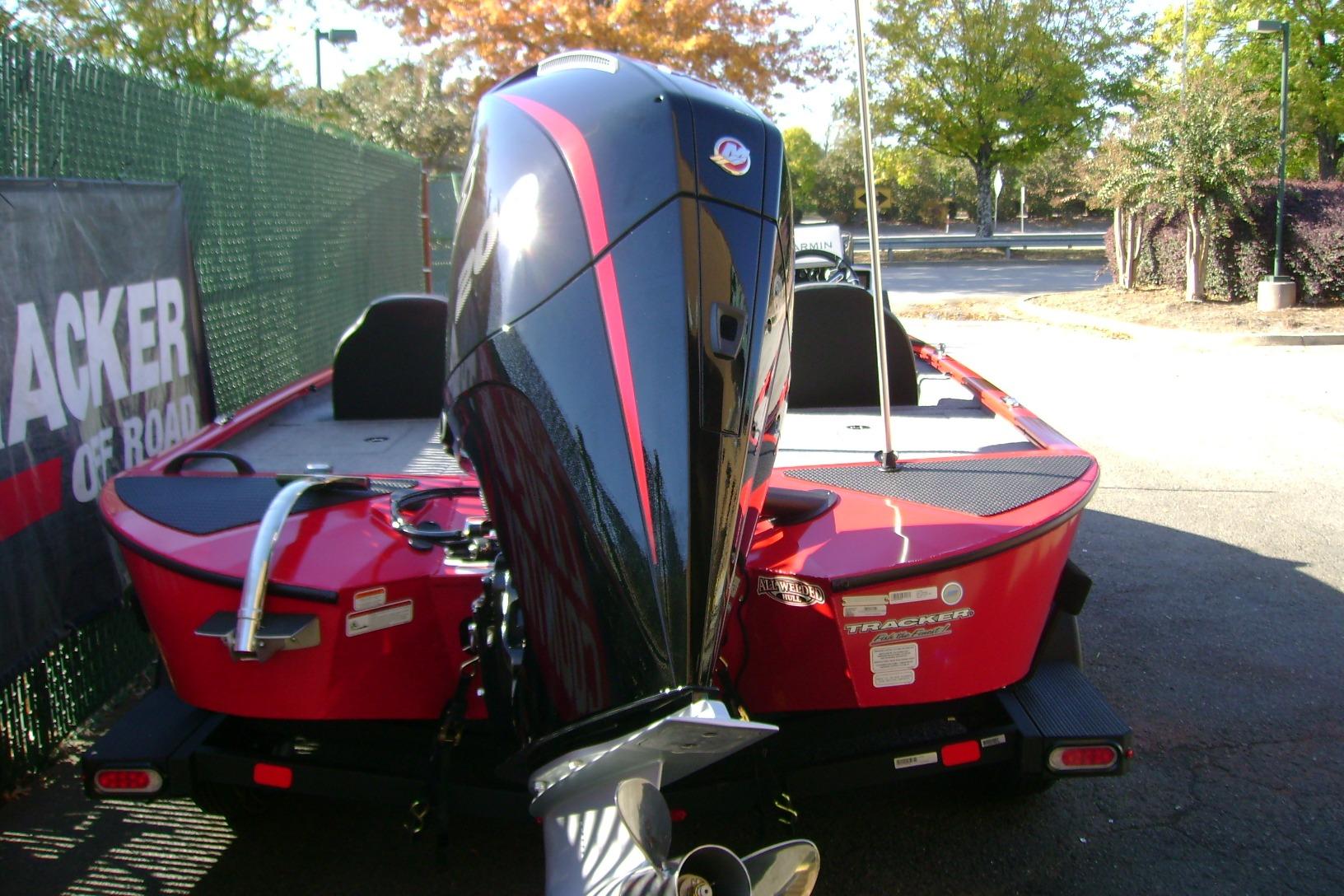 2026 Tracker Savage 215 boat with powerful outboard motor, parked outdoors.