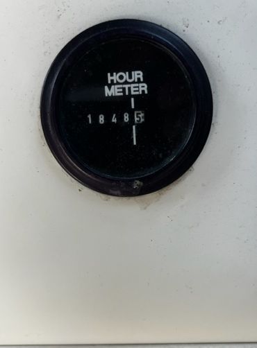An hour meter displays 1848.5 hours. It is set into a white panel.