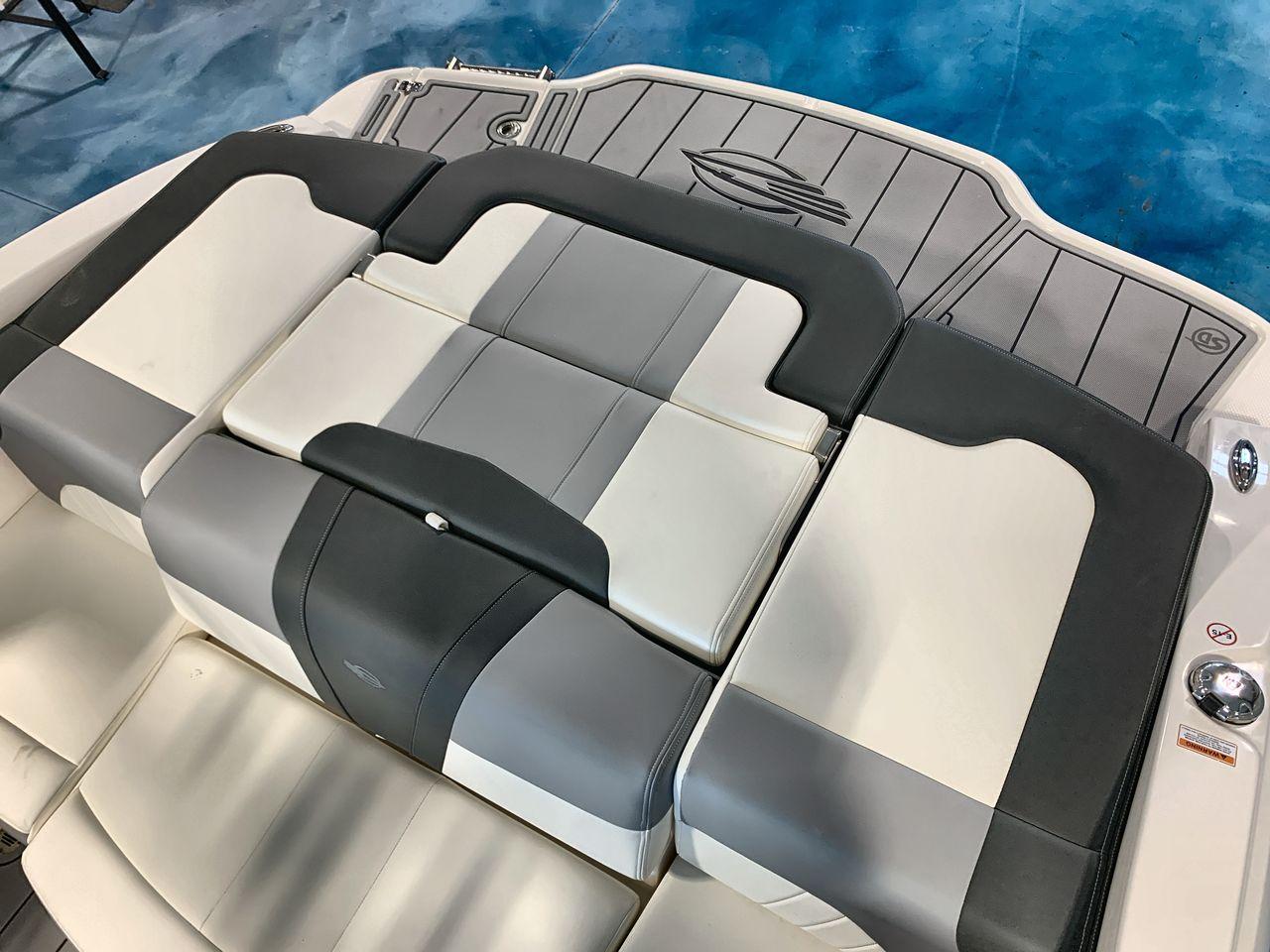 2025 Chaparral 21 SSi boat interior with gray and white cushioned seating.