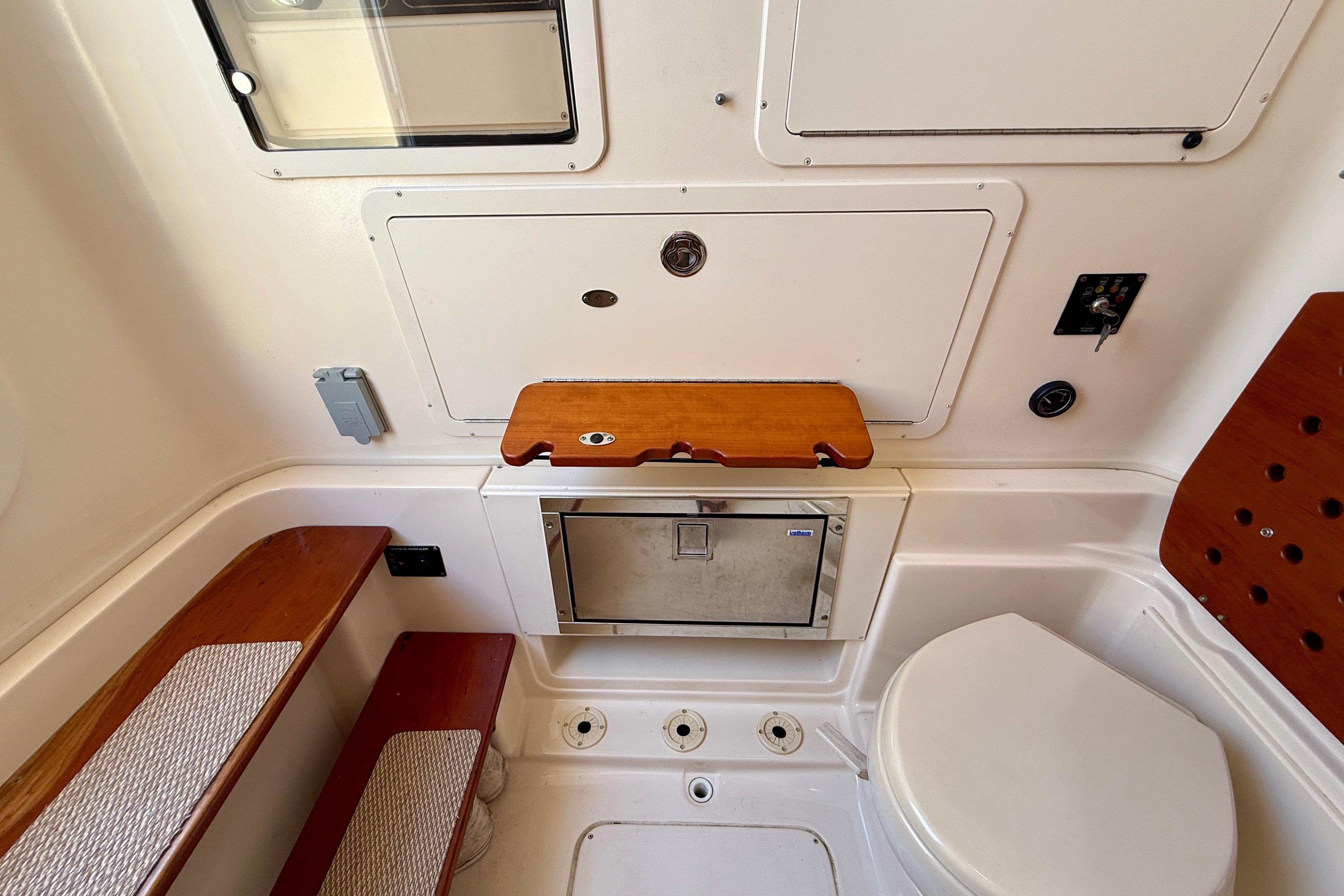 Interior of 2012 Grady-White Canyon 336 boat, featuring seating and storage compartments.