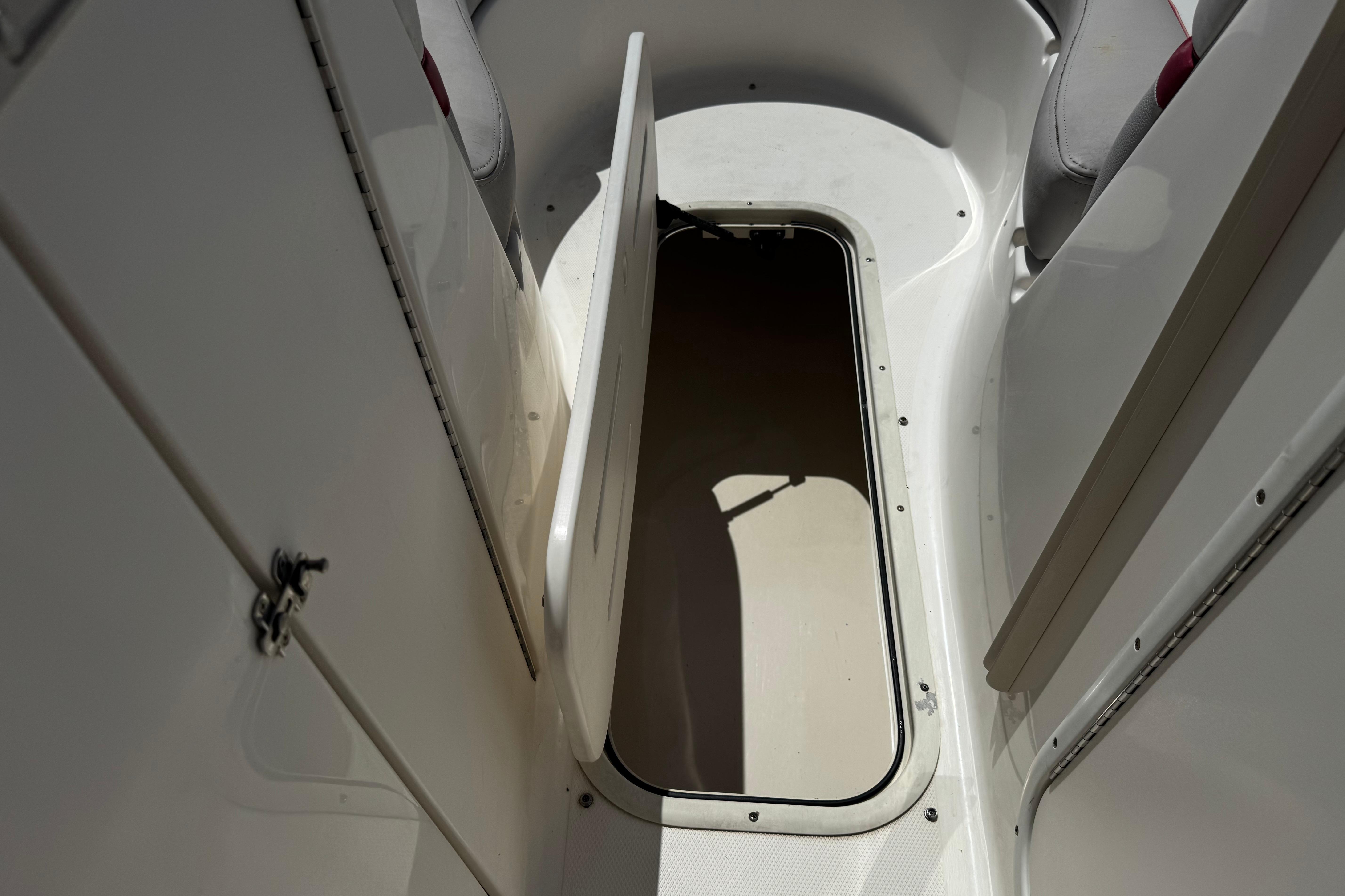Open storage compartment on a 2010 Bryant 255 boat interior.